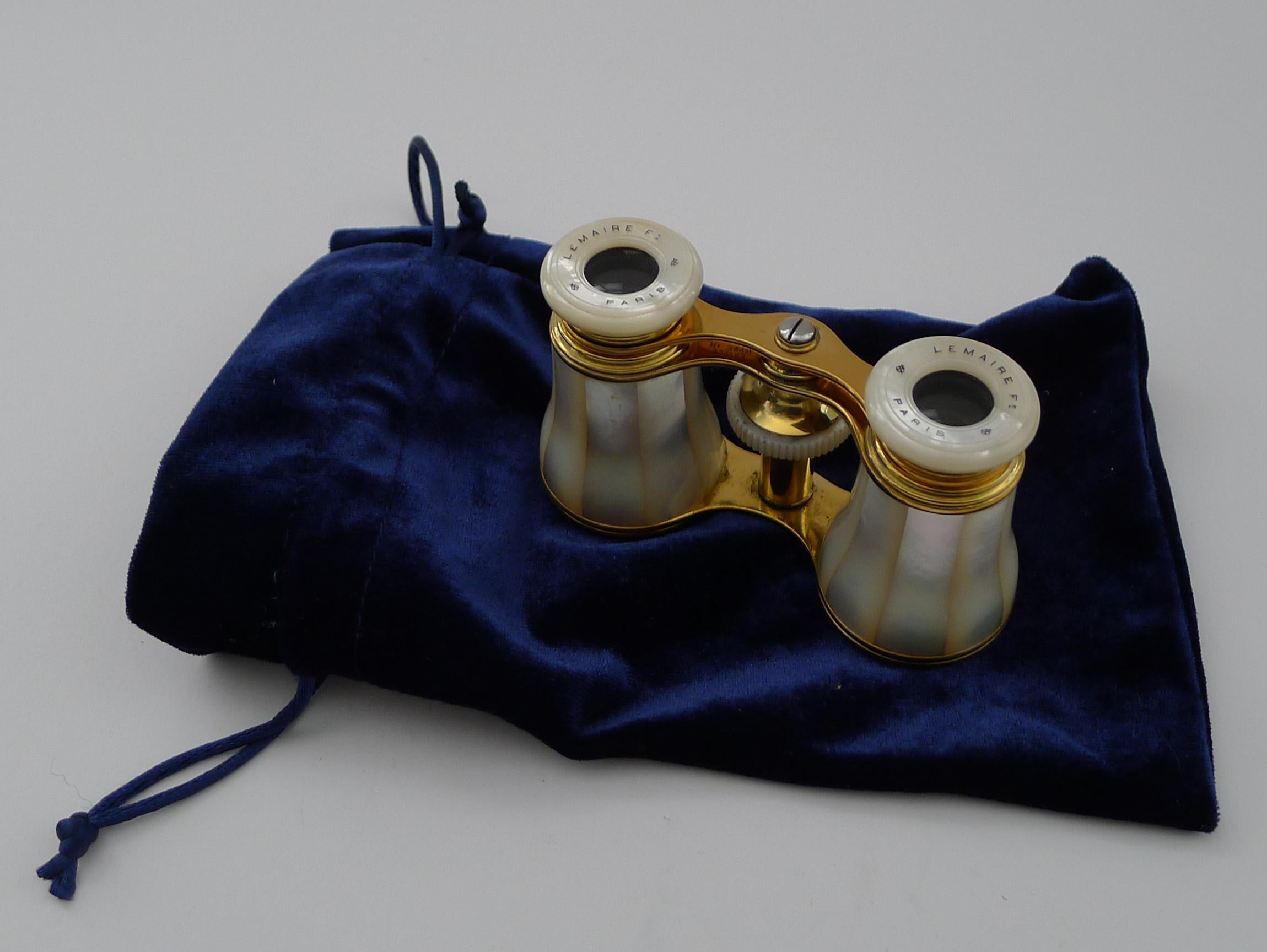 A very fine pair of Edwardian opera glasses made from Mother of Pearl and the polished brass; made by the creme de la creme of makers, LeMaire of Paris.

Both Mother of Pearl eye pieces are engraved and inked with the signature of this eminent maker