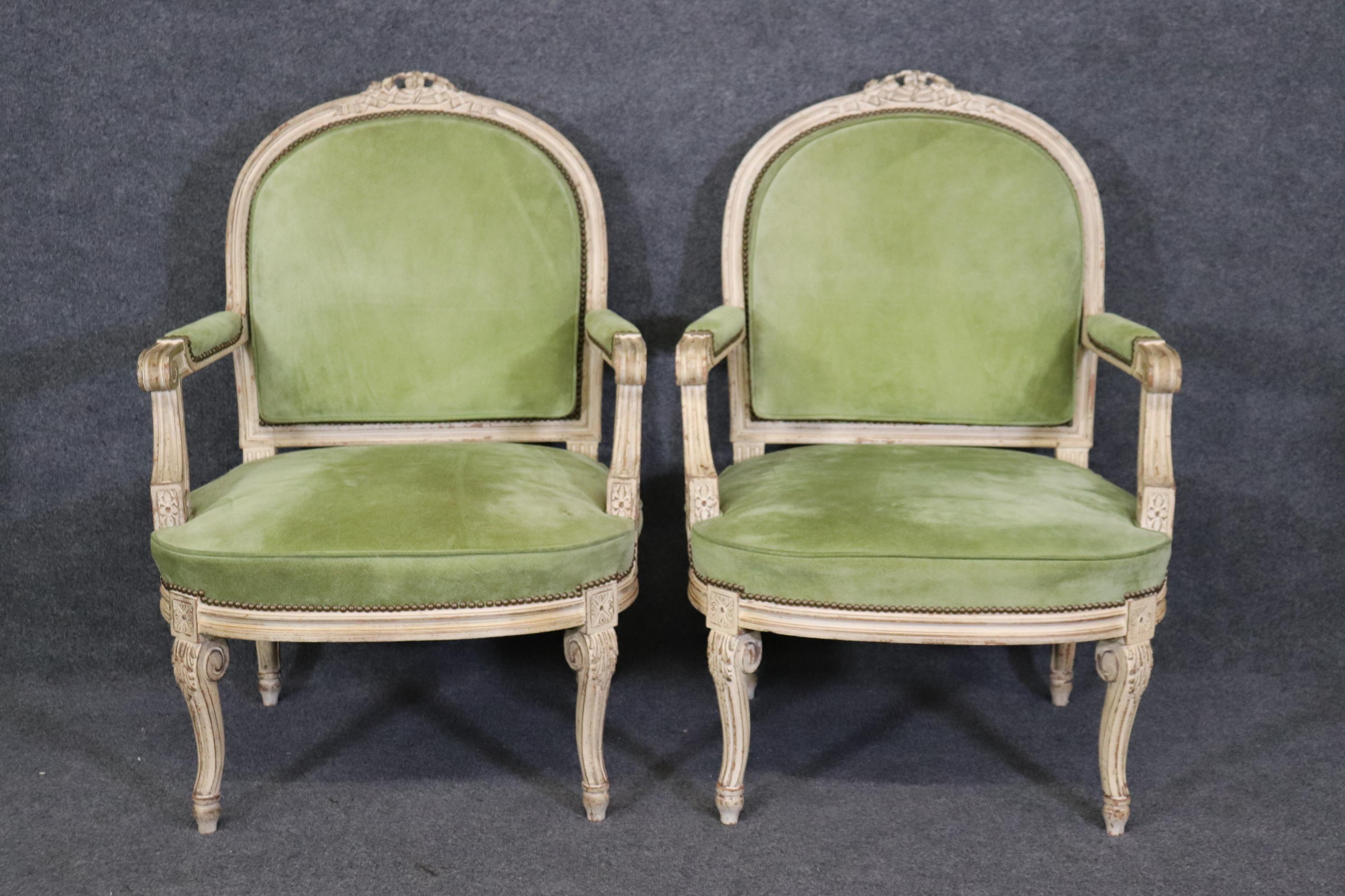 This is s a superb set of 2 ( we have an identical pair listed separately if interested) and they are upholstered in suede and in good condition with minor stains and signs of age as to be expected. The chairs date to teh 1940s and measure 38.75
