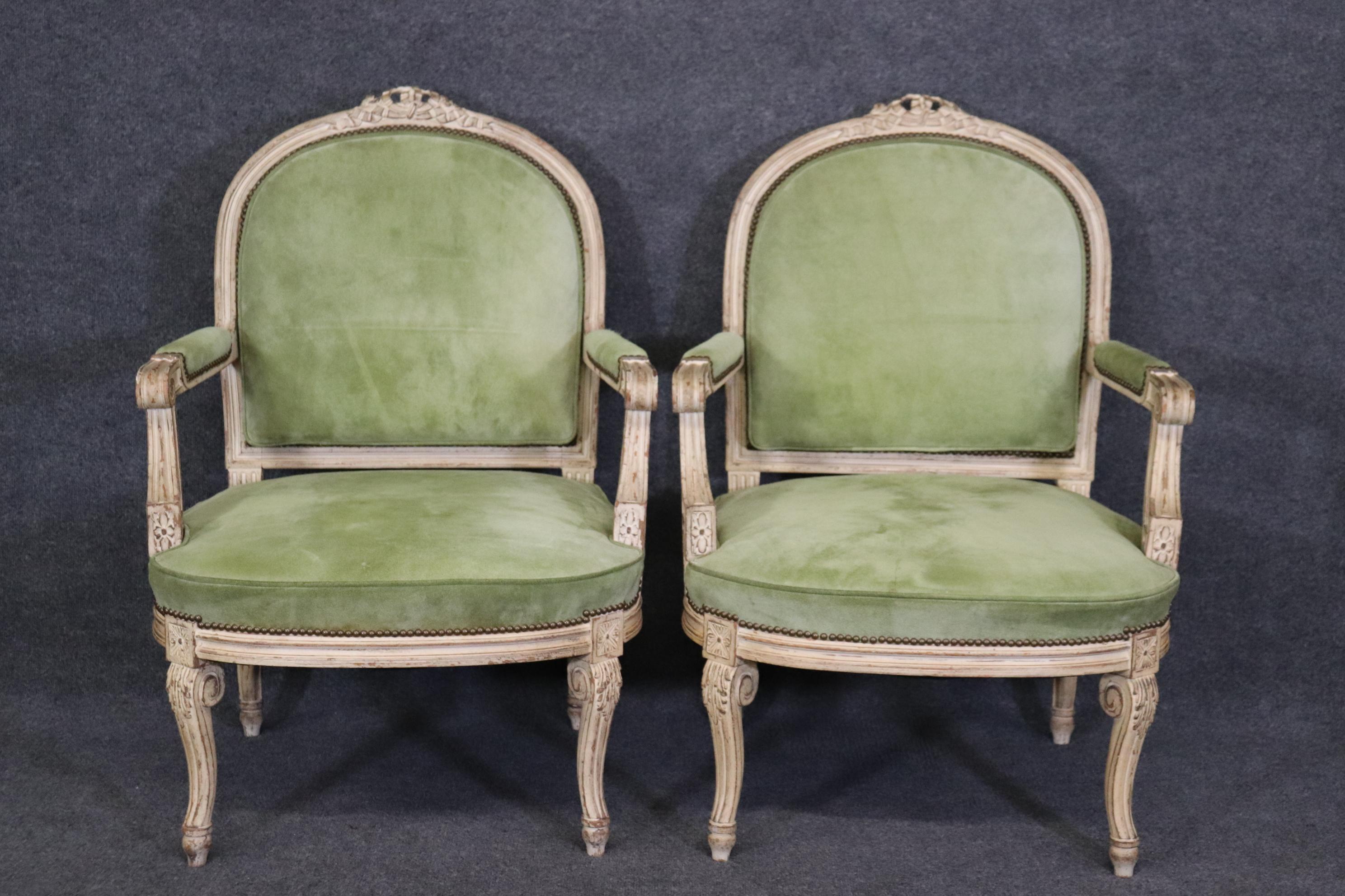This is s a superb set of 2 ( we have an identical pair listed separately if interested) and they are upholstered in suede and in good condition with minor stains and signs of age as to be expected. The chairs date to teh 1940s and measure 38.75