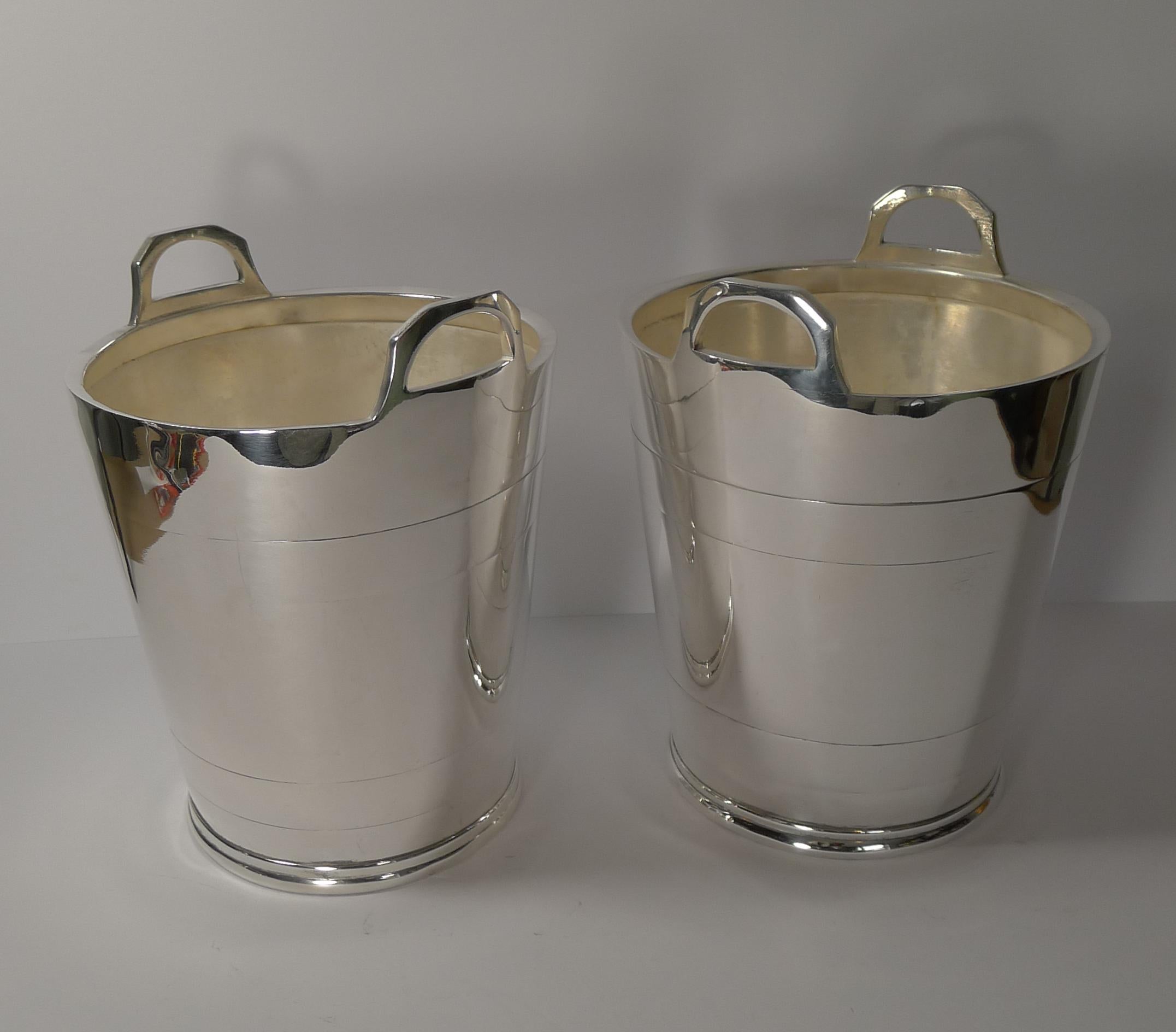 A truly fine pair of vintage English silver plated wine coolers or buckets both in the form of a coopered wooden pail or bucket with handles to each side.
Just back from our silversmith, professionally polished to shine with all scratches etc.