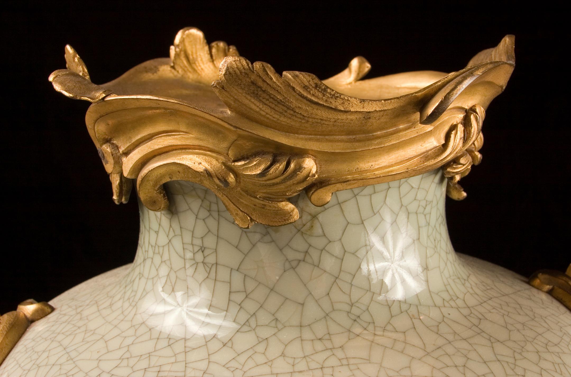 Ein prächtiges Paar chinesischer Vasen aus Celadon-Craqule-Ware aus dem frühen 18.  Als sie im 19. Jahrhundert nach Frankreich exportiert wurden, fügten die Franzosen Bronzebeschläge hinzu. Hier sehen wir Oberteile, seitliche Griffe und Sockel aus