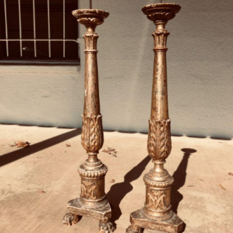 These beautiful pricket sticks are in all-original condition, with lovely gilding and carving to the front, the pricket top over acanthus carved columns ending on a cylindrical base having a corona and insignia upon a tri-foot plinth base. Expected