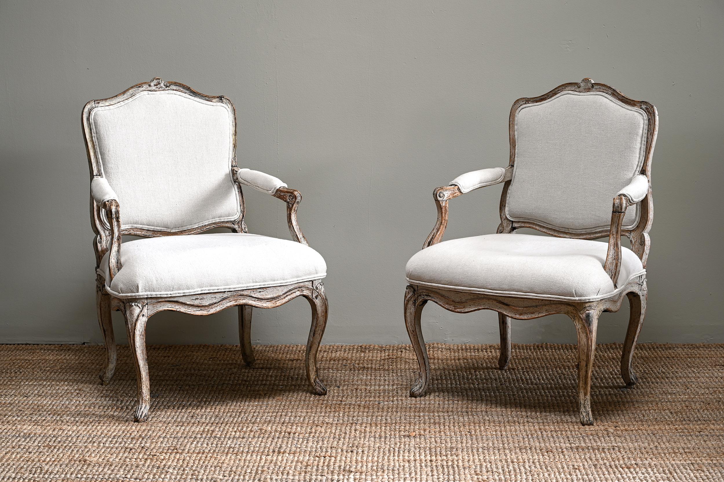 Fine pair of 18th century French Rococo armchairs with great proportions and in their original finish with good patination. Newly upholstered. Ca 1750 France.