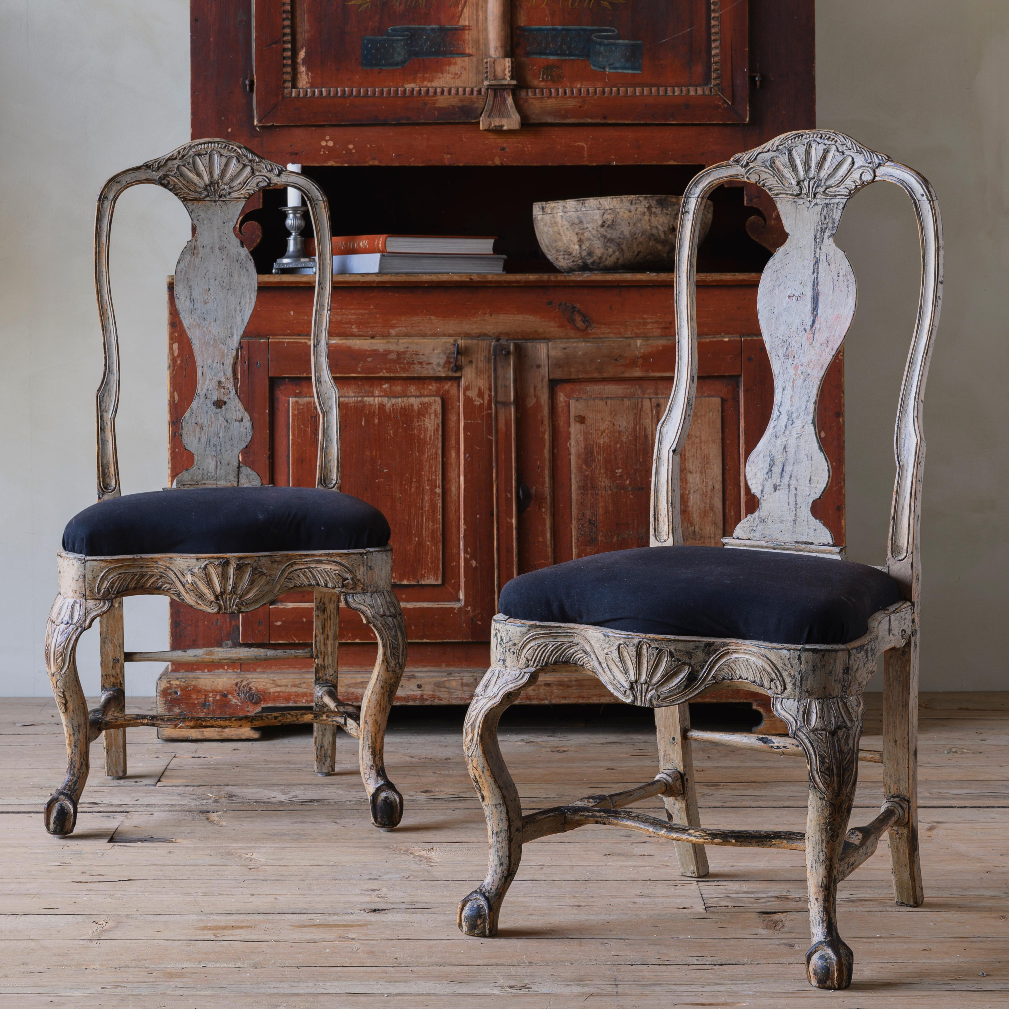 Fine pair of 18th century Swedish Rococo chairs in their original finish and rich in detailed carvings throughout. Ca 1760 Sweden.