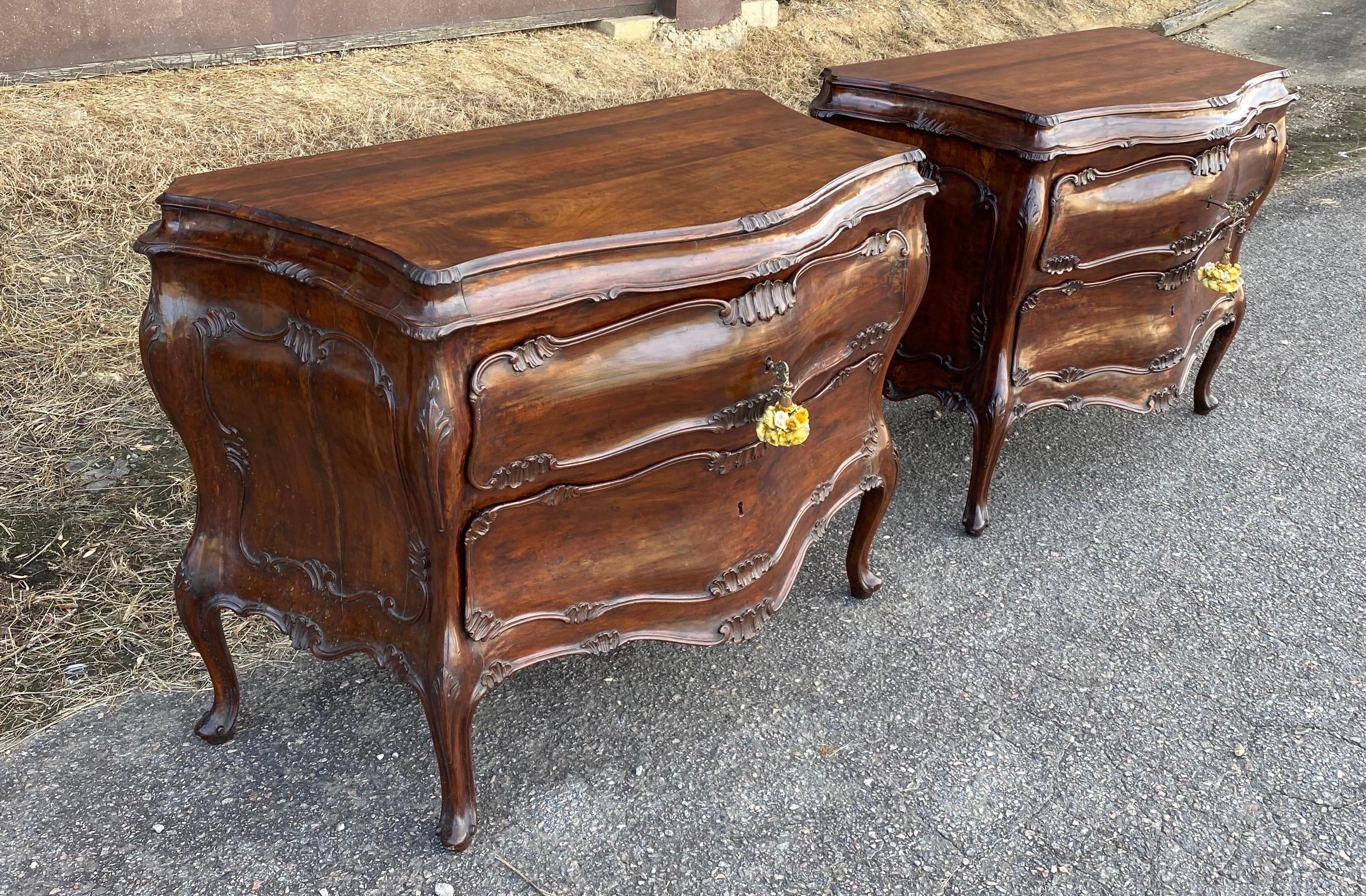Fine pair of 18th century Venetian Rococo bombe bedside chests of drawers. Serpentine form, scrolled feet, carved drawers, original locks. The height on these beauties are perfect to use as side tables or bedside chests.