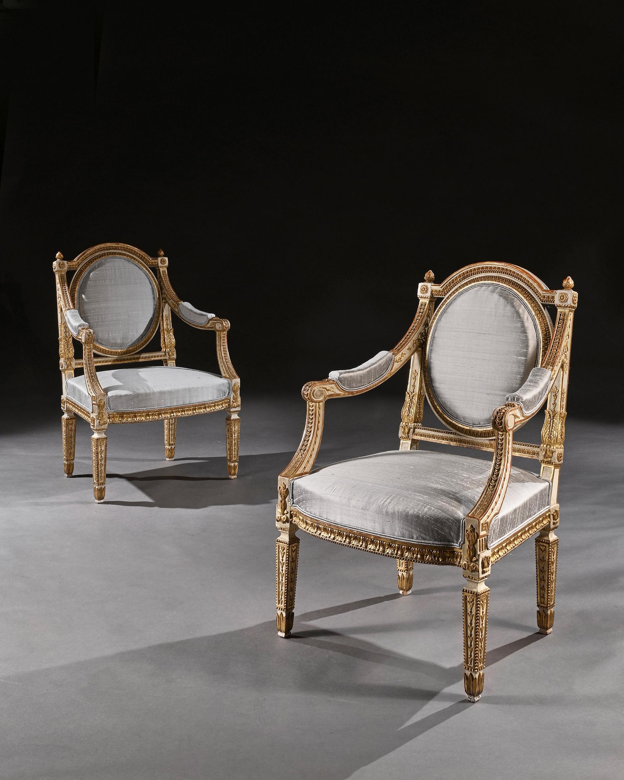 Extremely fine pair of decorative 19th century Italian painted and parcel gilt armchairs of neoclassical design,

Italian, late 19th century, circa 1880.

Oozing style these very attractive parcel gilt armchairs have husk and foliate-carved