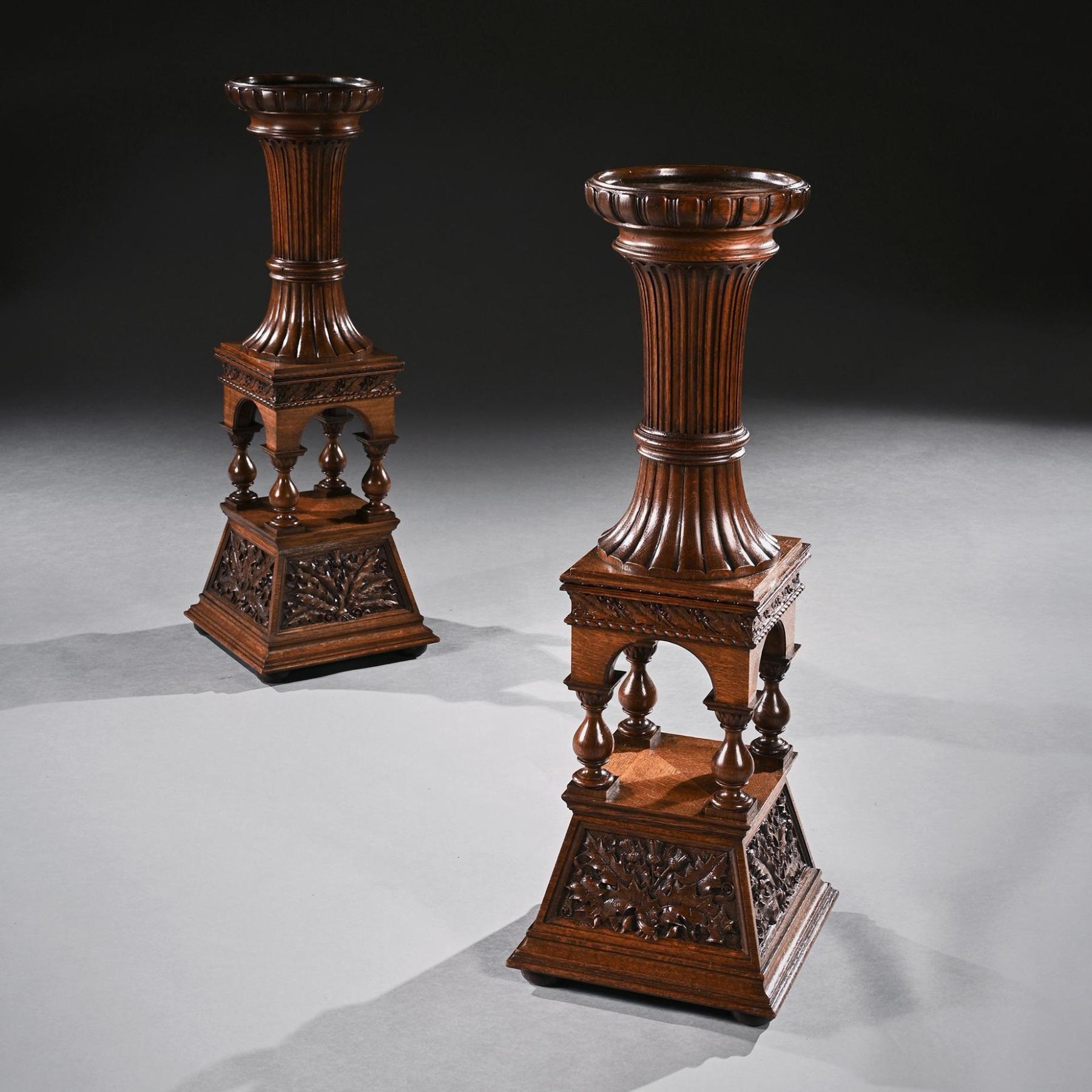 Fine pair of 19th century Arts & Crafts oak torcheres, Robert Lorimer.

A fine pair of architectural Arts & Crafts oak torchere / stands in the manner of Sir Robert Lorimer.

Scottish Circa 1880.

Finely carved, the lobed circular capitals above