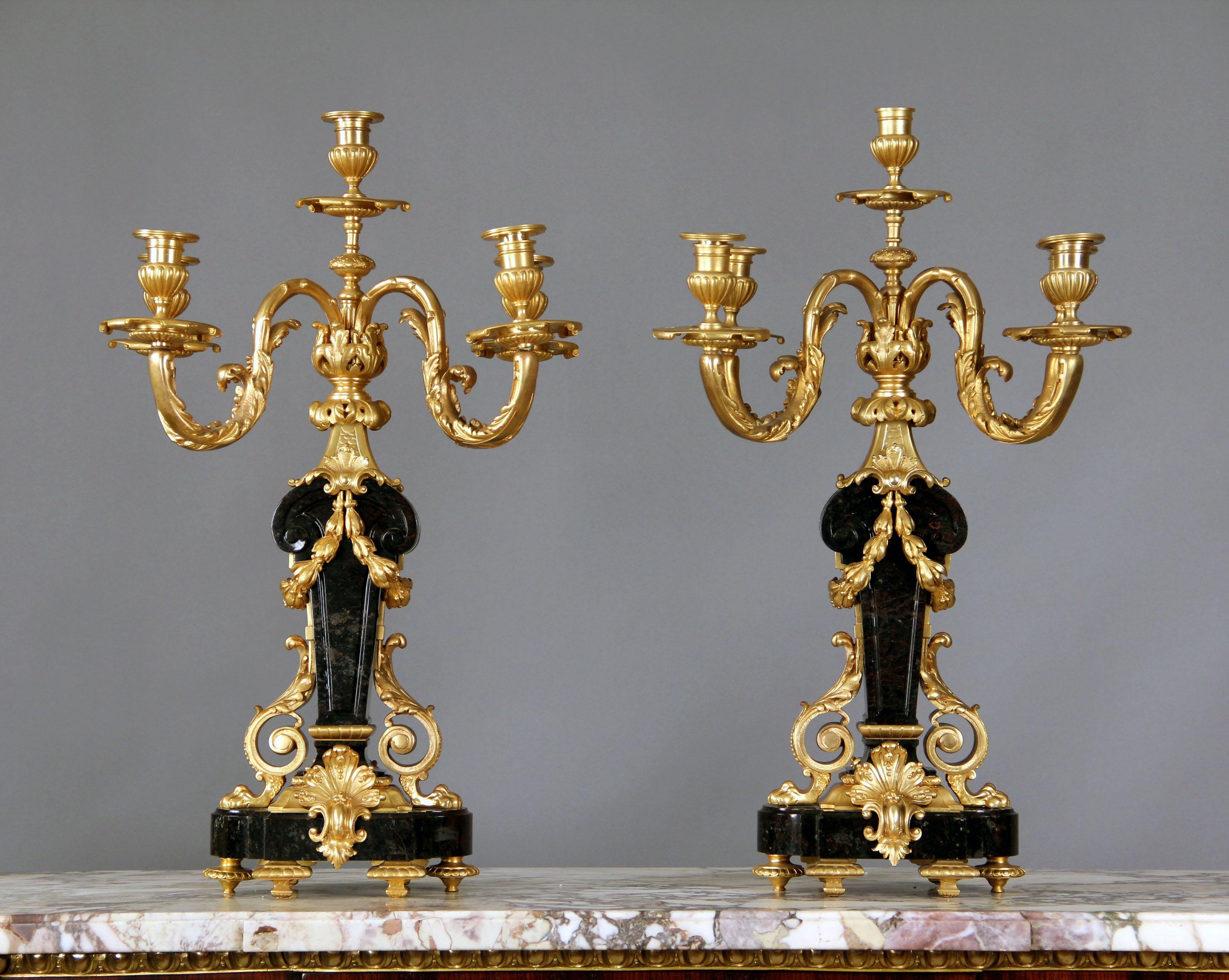 A fine pair of late 19th century gilt bronze and marble five-light candelabra.

Bronze-mounted black Belgium marble with four foliate branches about a central stem.