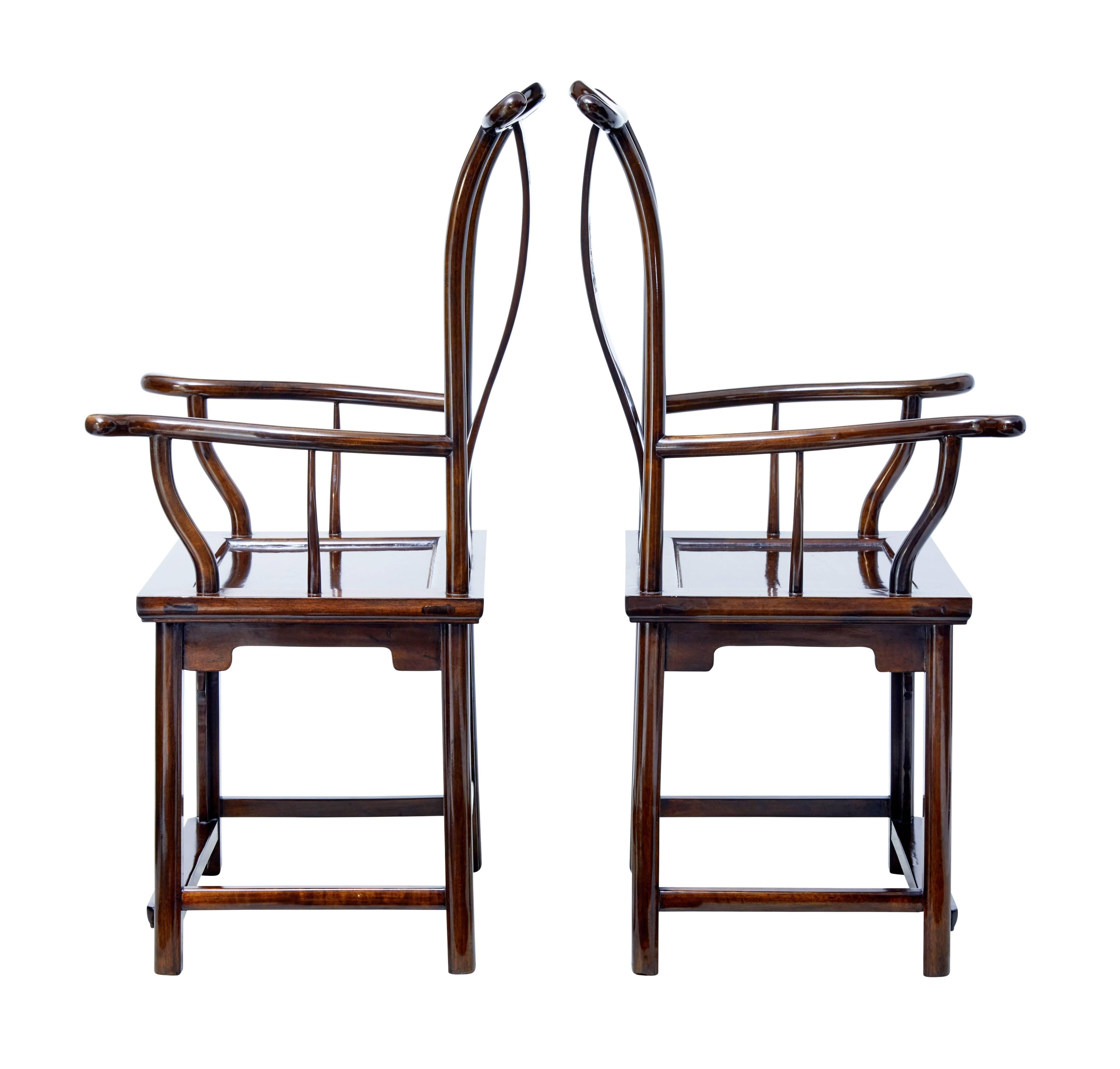 Elegant pair of Chinese export yoke back armchairs, circa 1890.

Good color and patina, with carved design in the solid on the backrest.

Yoke backrest is complimented by the beautiful flowing arms. Panel seat, with carved decoration to the