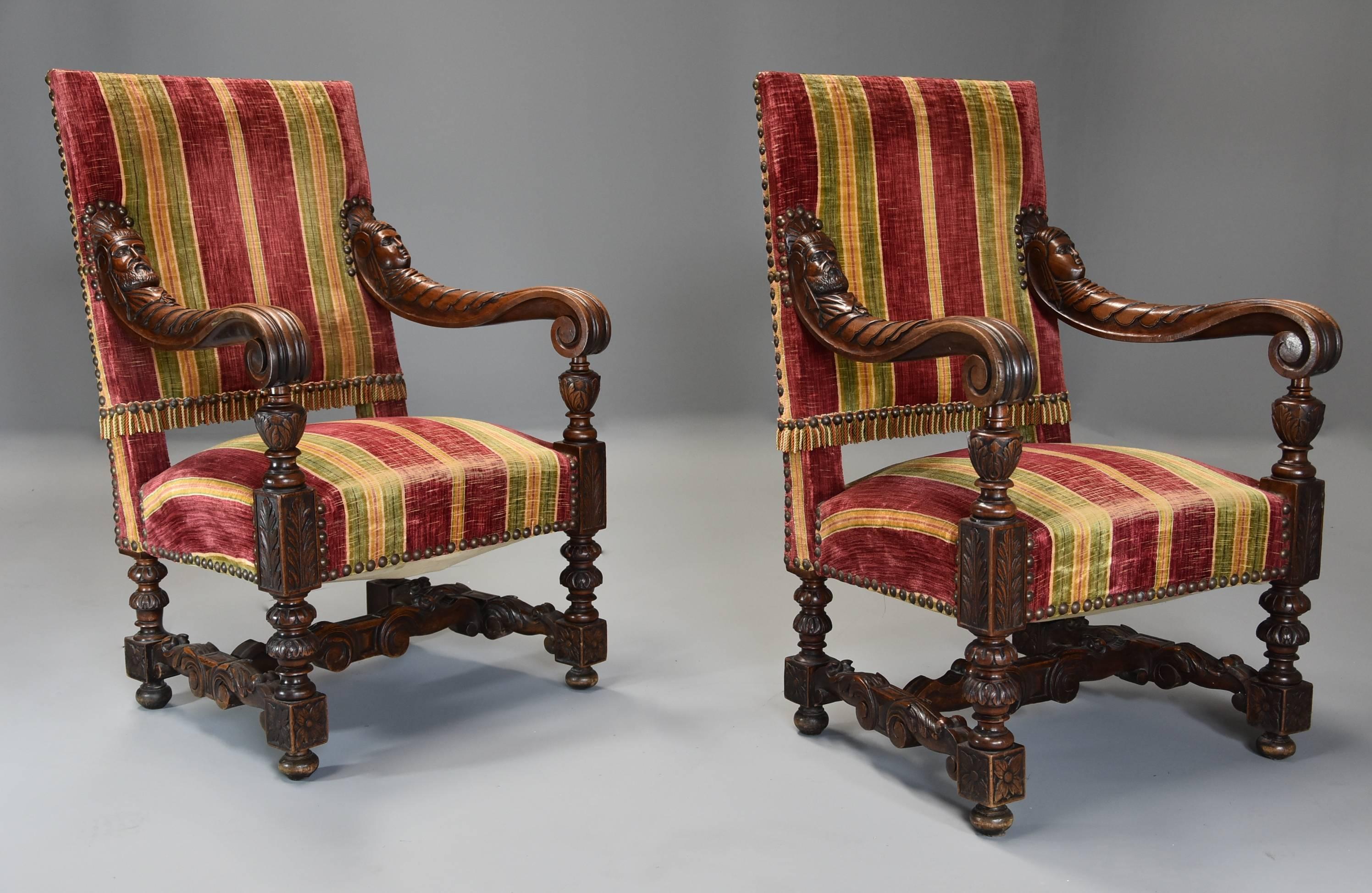A fine and imposing pair of 19th century French walnut open armchairs in the Baroque style.

This striking pair of chairs consist of an upholstered back leading down to superbly carved scroll arms with carved male and female heads supported by