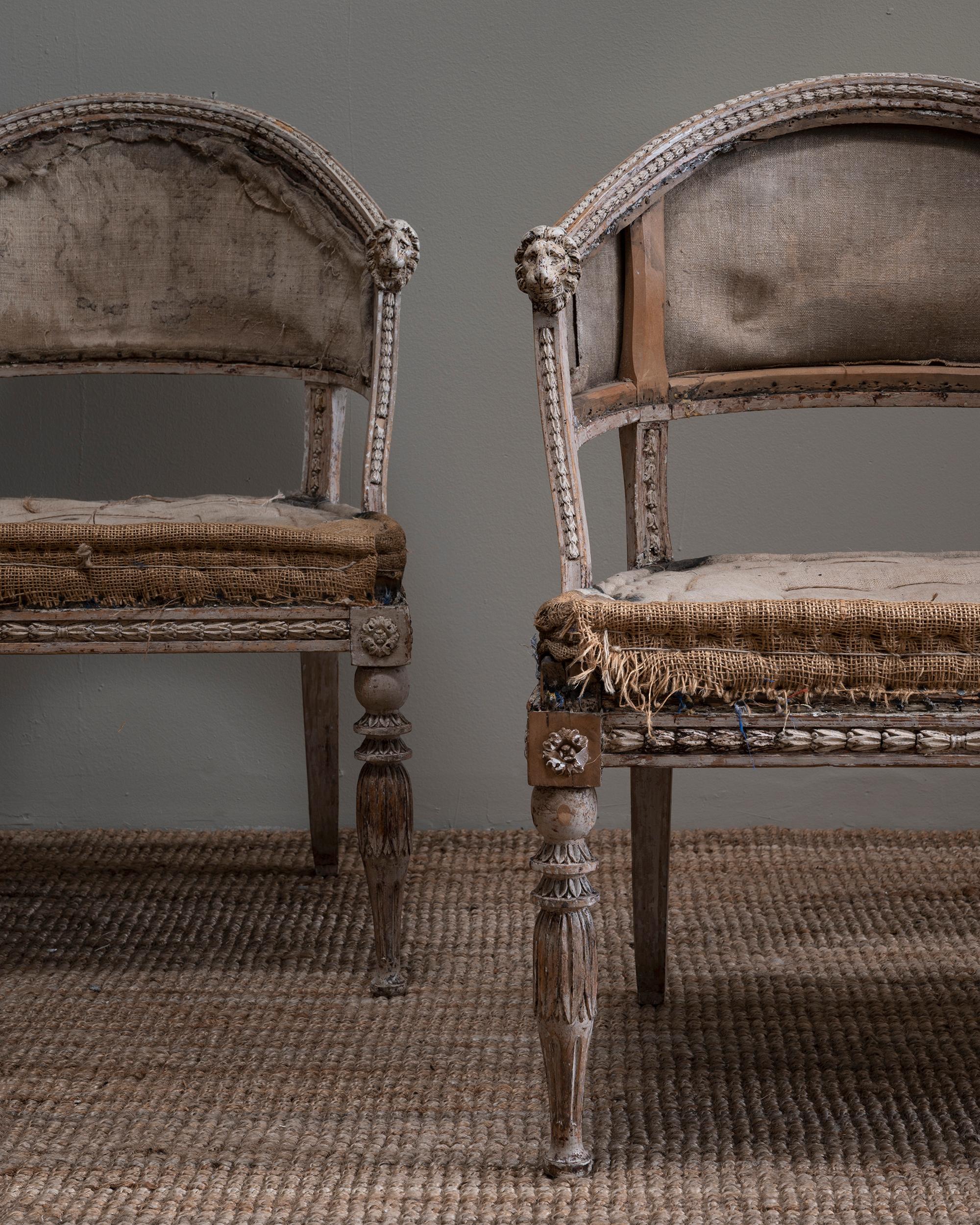 Fine pair of early 19th century late Gustavian barrel back armchairs in their original condition with lion head carvings on the armrests, needs upholstery. Ca 1810 Sweden.