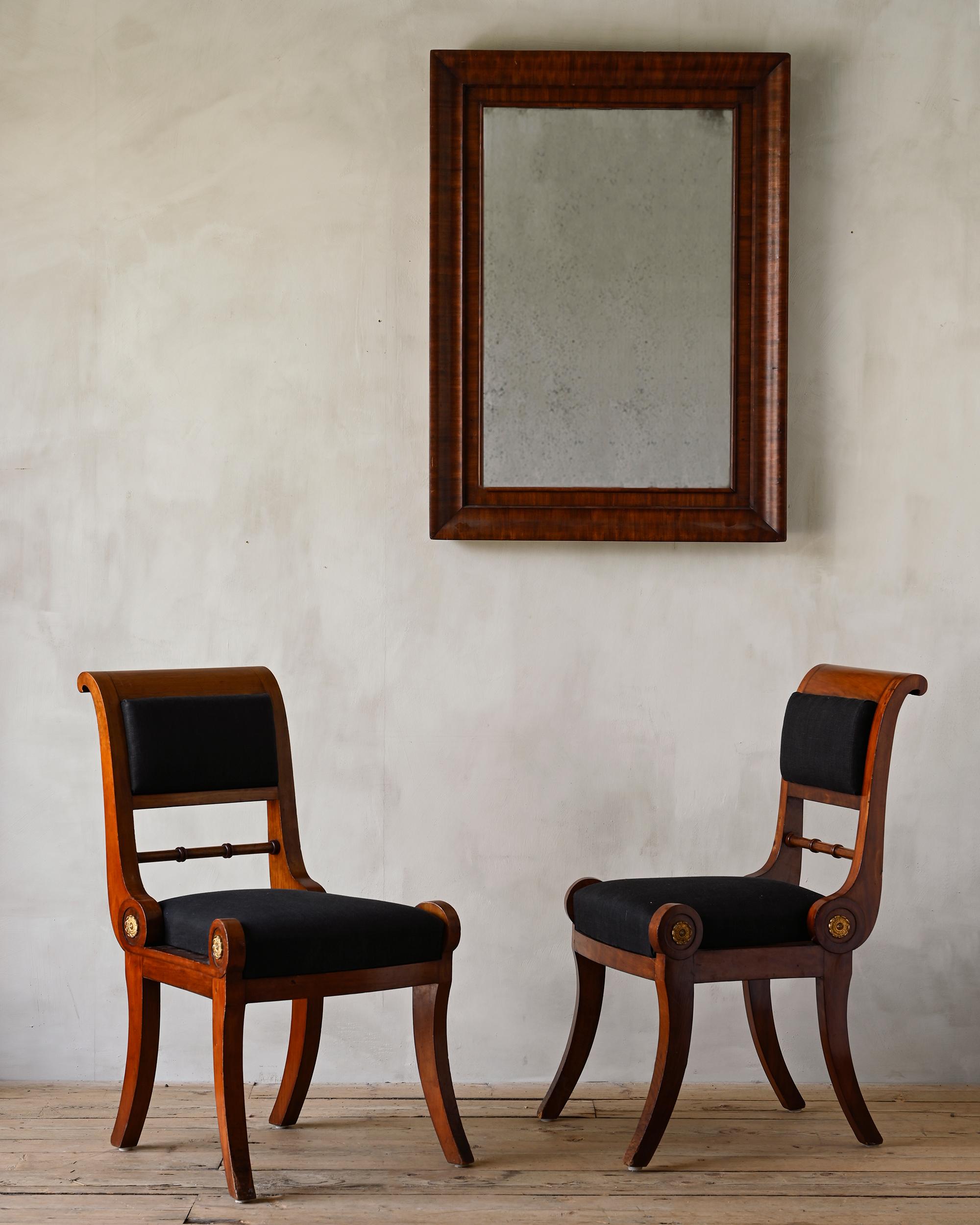 Fine pair of 19th century Swedish Empire chairs veneered with mahogany after a drawing by C. Sundvall (Architect 1754-1831). For the interior of the red salon at Skottorp, Halland 1820 - 1830.

Skottorp's castle is nobly and calmly kept, the