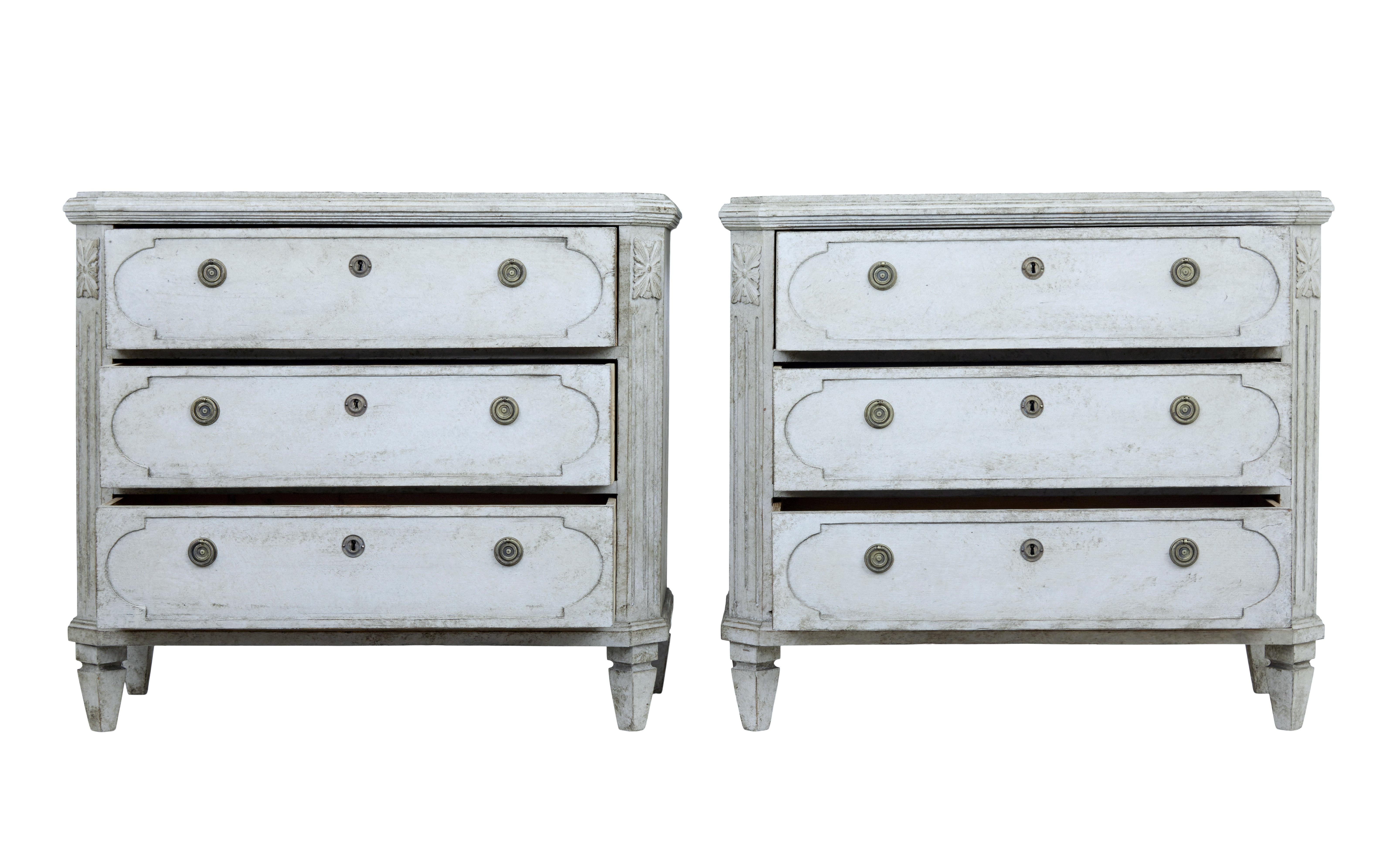 Pair of Gustavian inspired chest of drawers, circa 1870.

3 drawer chests with shaped fronts, later ring handles and escutheons. Canted corners with applied acanthus detailing.

Working locks and key. Standing on short tapered feet.

Later