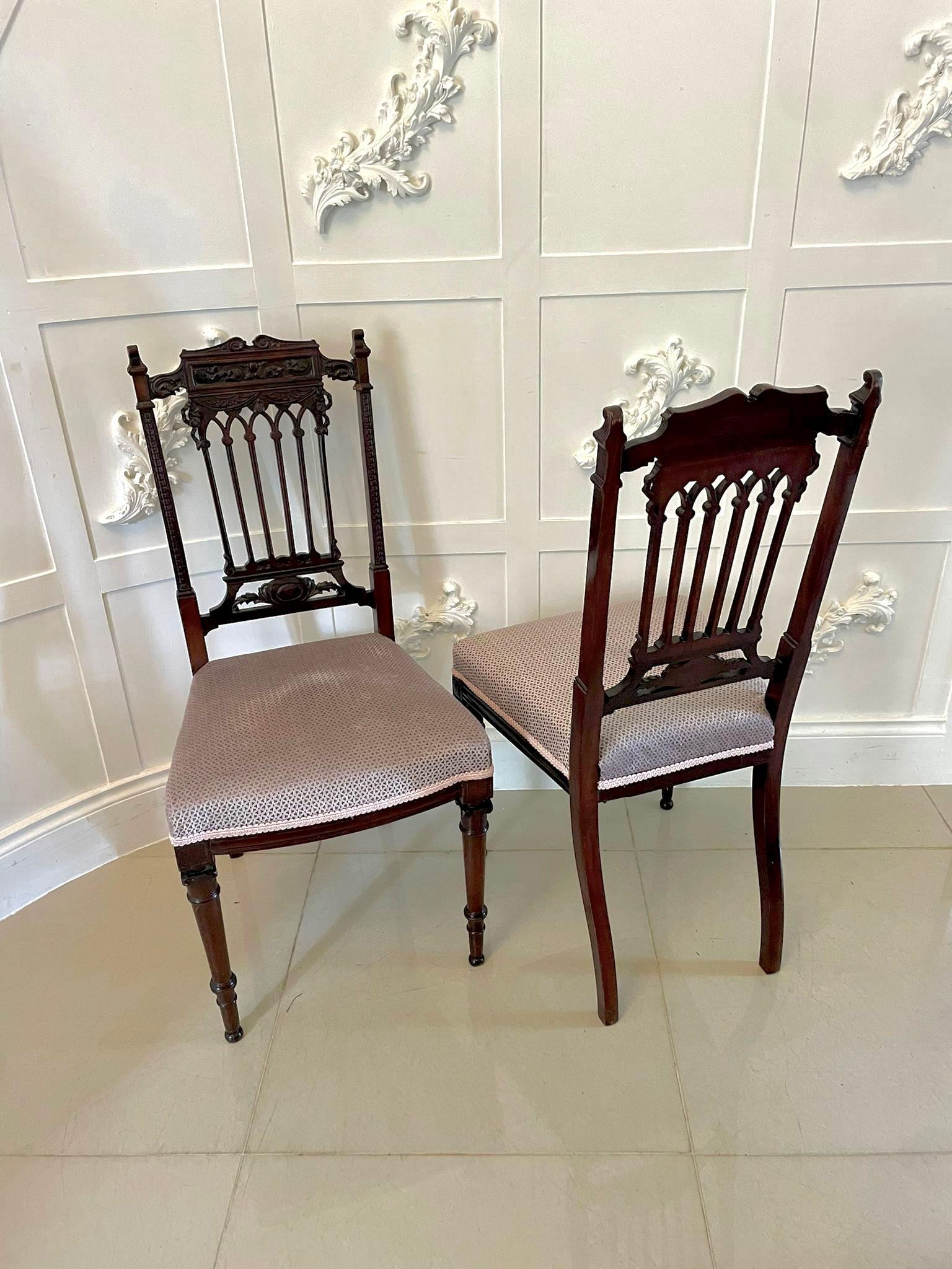 Fine pair of antique Victorian carved mahogany side chairs having a magnificent carved mahogany top rail and carved splat to the centre. Newly reupholstered seats and standing on elegant square tapering carved legs to the front and out swept back