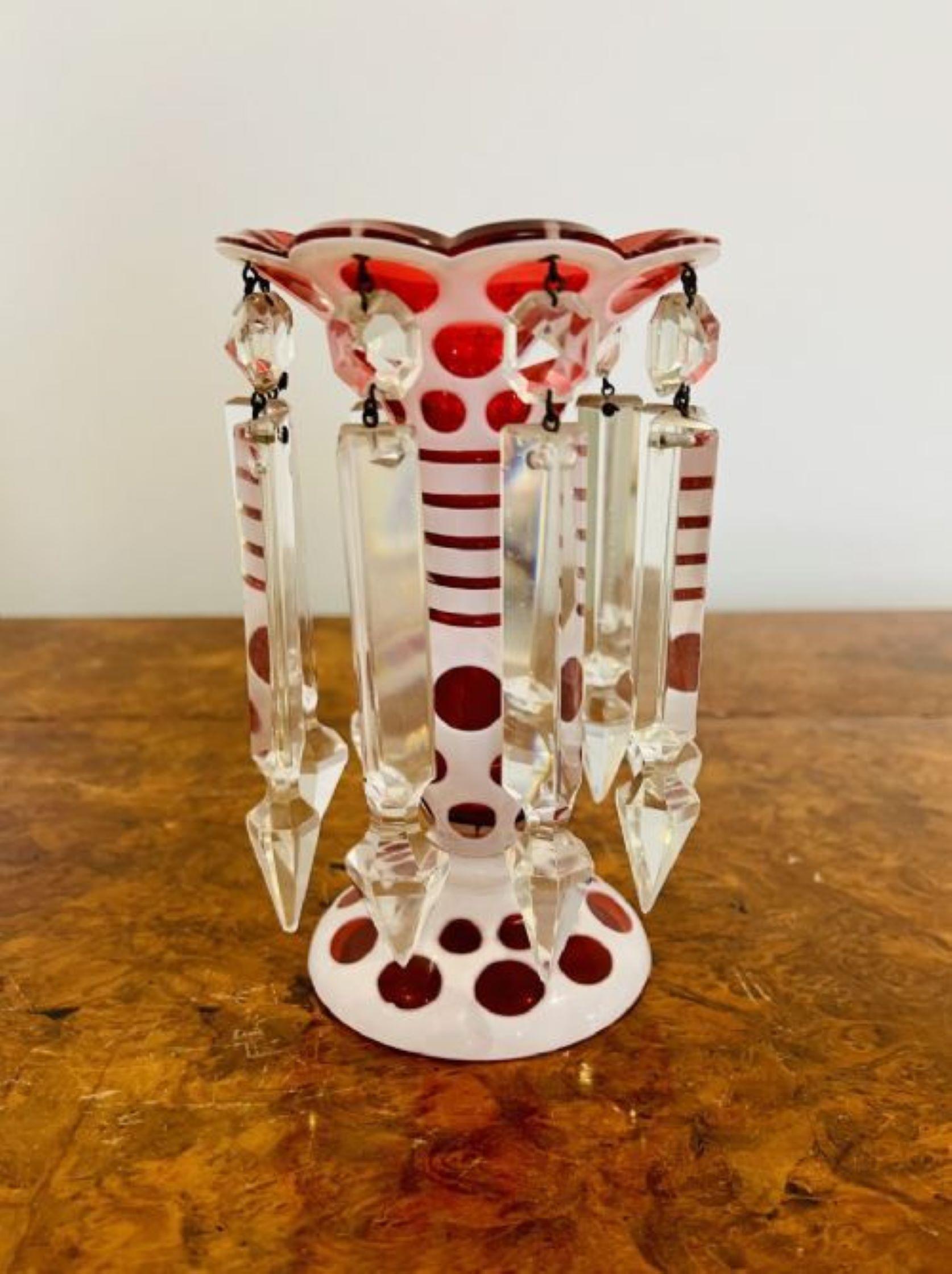 Fine pair of antique Victorian overlaid lustres, having ruby glass bodies overlaid in white with slice cut rounded decoration, each set has nine hanging prismatic clear glass drops on circular bases 