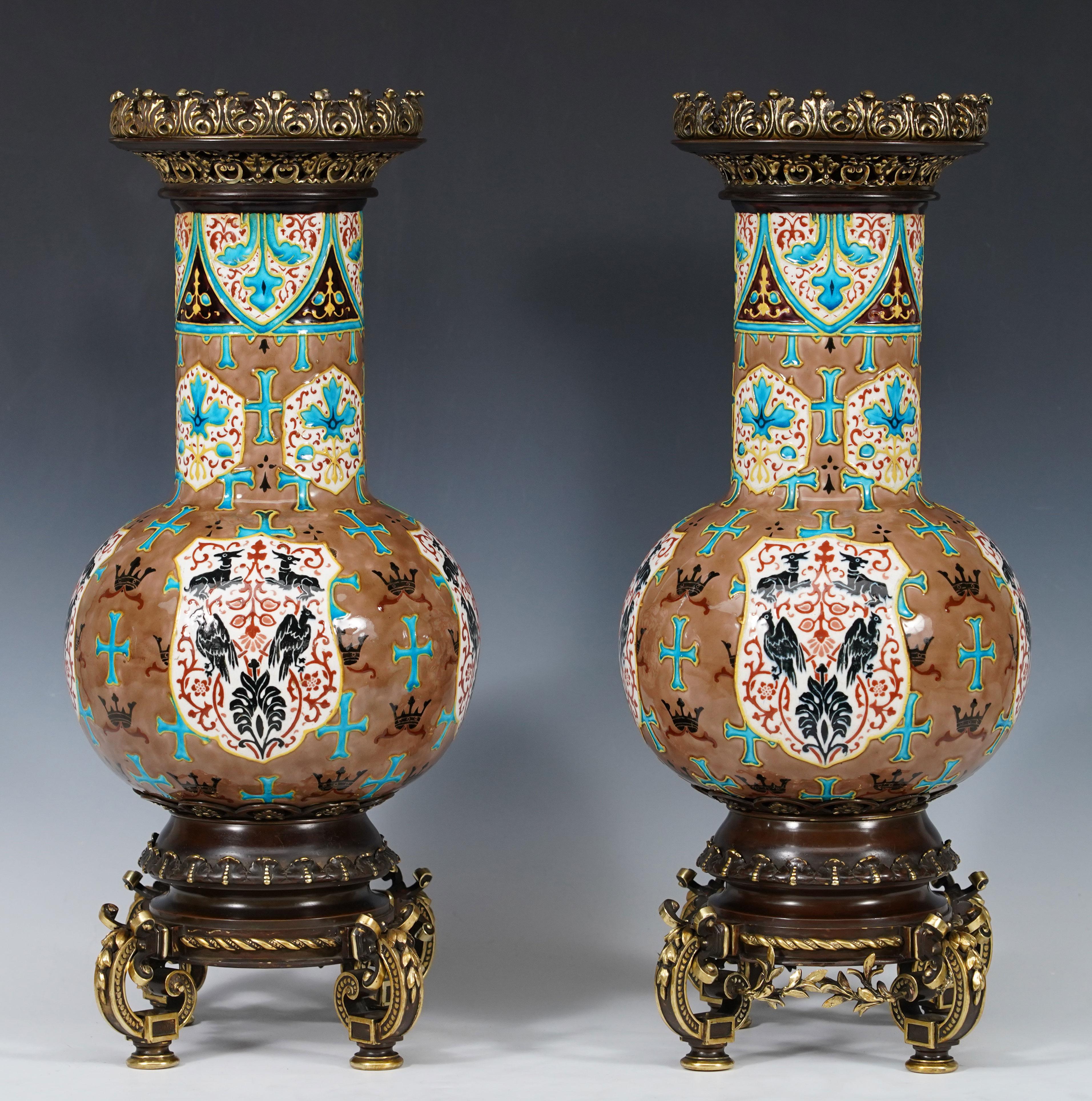 Manufacturer’s Mark of J.Vieillard & Cie à Bordeaux 

A fine pair of polychrome earthenware baluster vases, decorated on a brown background with anchored crosses, crowns and ermines, heraldic medallions featuring deer and birds of prey. 
The whole