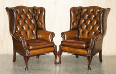 FINE PAIR OF CHESTERFIELD CHESTNUT BROWN LEATHER WINGBACK ARMCHAIRS & FOOTSTOOLs