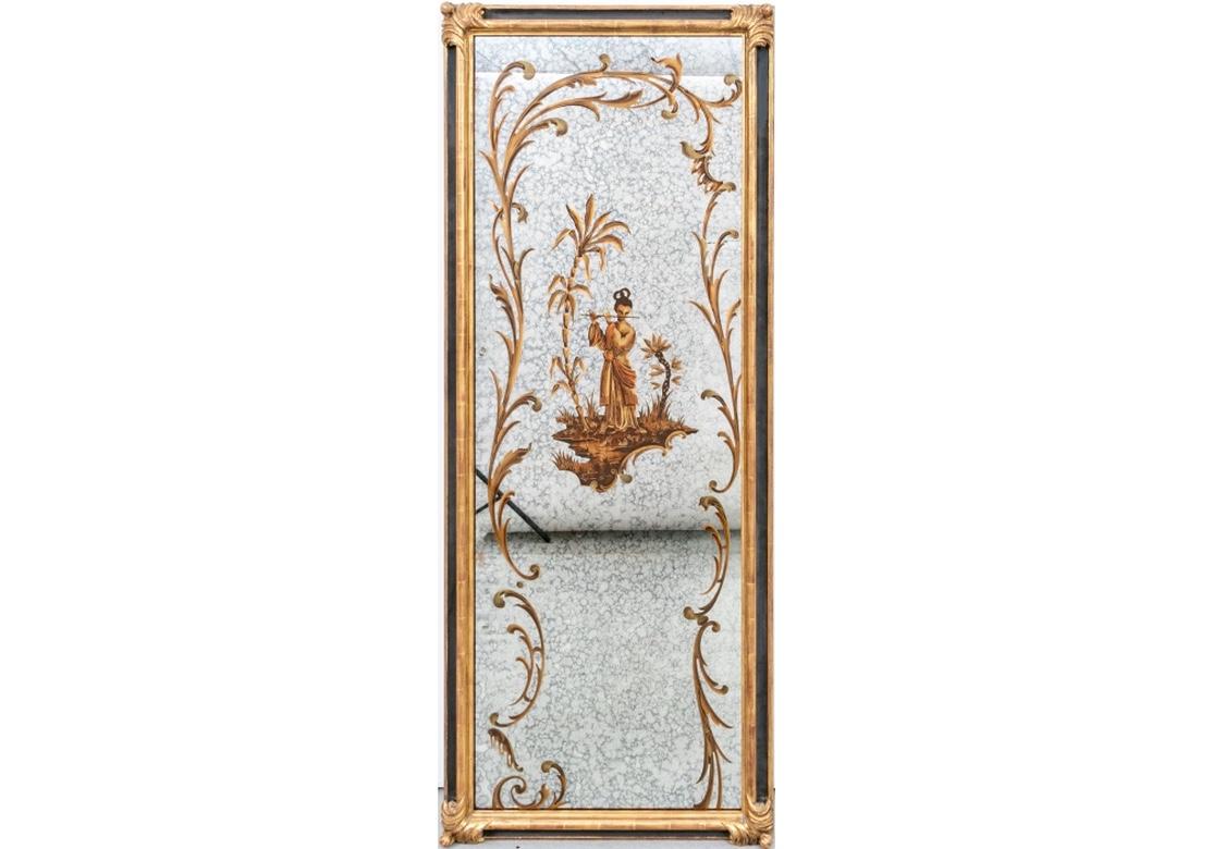 A fine and decorative pair of Hollywood Regency style wall mirrors with good size and serene aspect. The mottled mirrors with fine painted and gilt decoration with leafy scrolled frames for the center figures. One female figure plays the flute, the