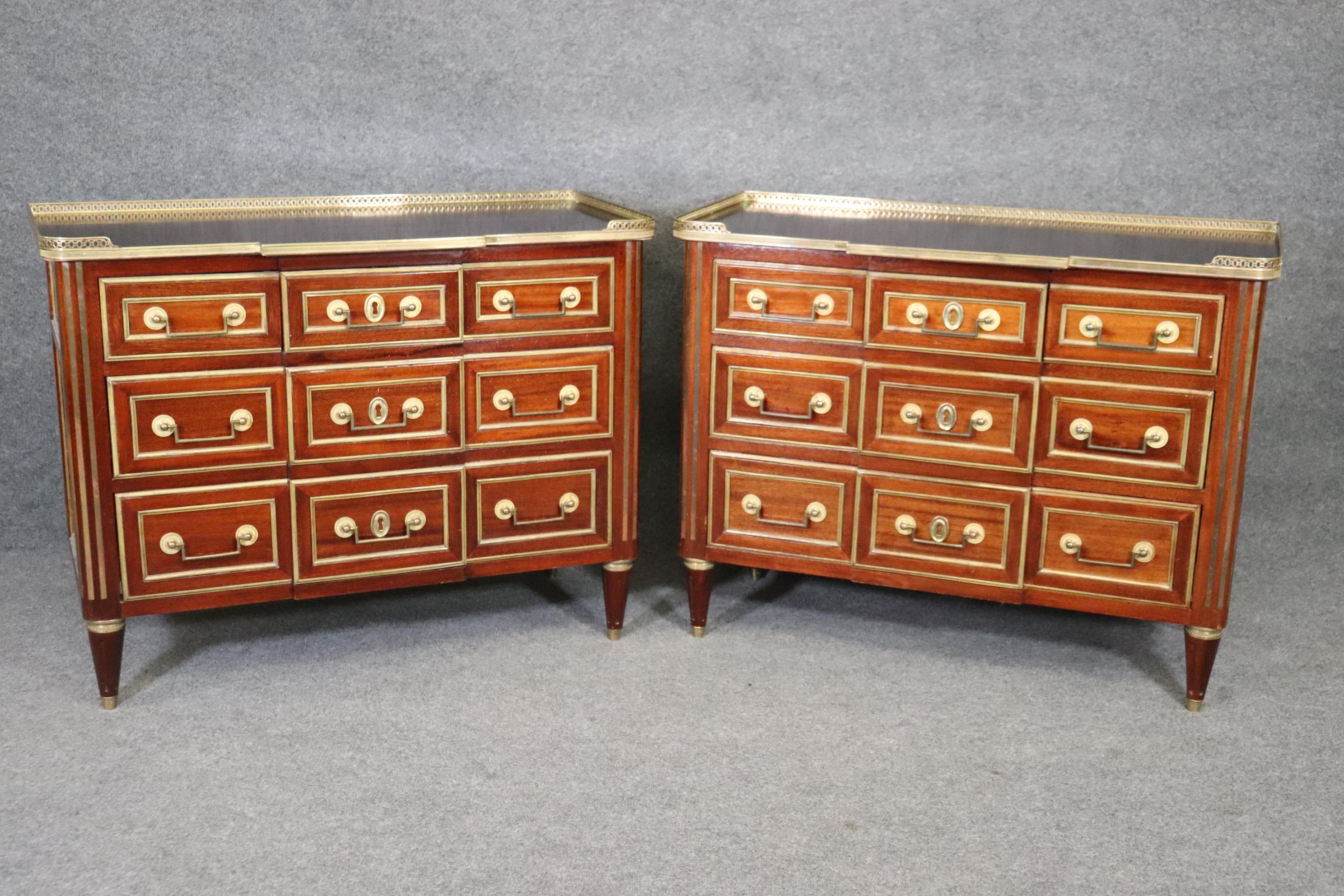 This is a rare and special pair of extremely beautiful Maison Jansen style commodes. They have absolutely gorgeous bronze ormolu mounts, hardware and a gallery surrmounting a gorgeous mahogany top. The commodes have metal drawer slides added later
