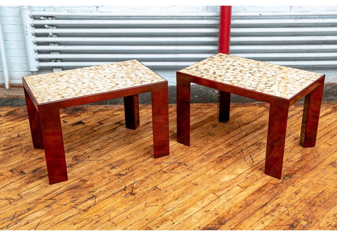 Pair of rectangular side tables custom lacquered in a cracked eggshell finish on the tops in ecru, brown and tan with spiderweb black lines. The frames in an oxblood red lacquer with triangular shaped legs. 
Measures: 32” wide by 20.5 depth by