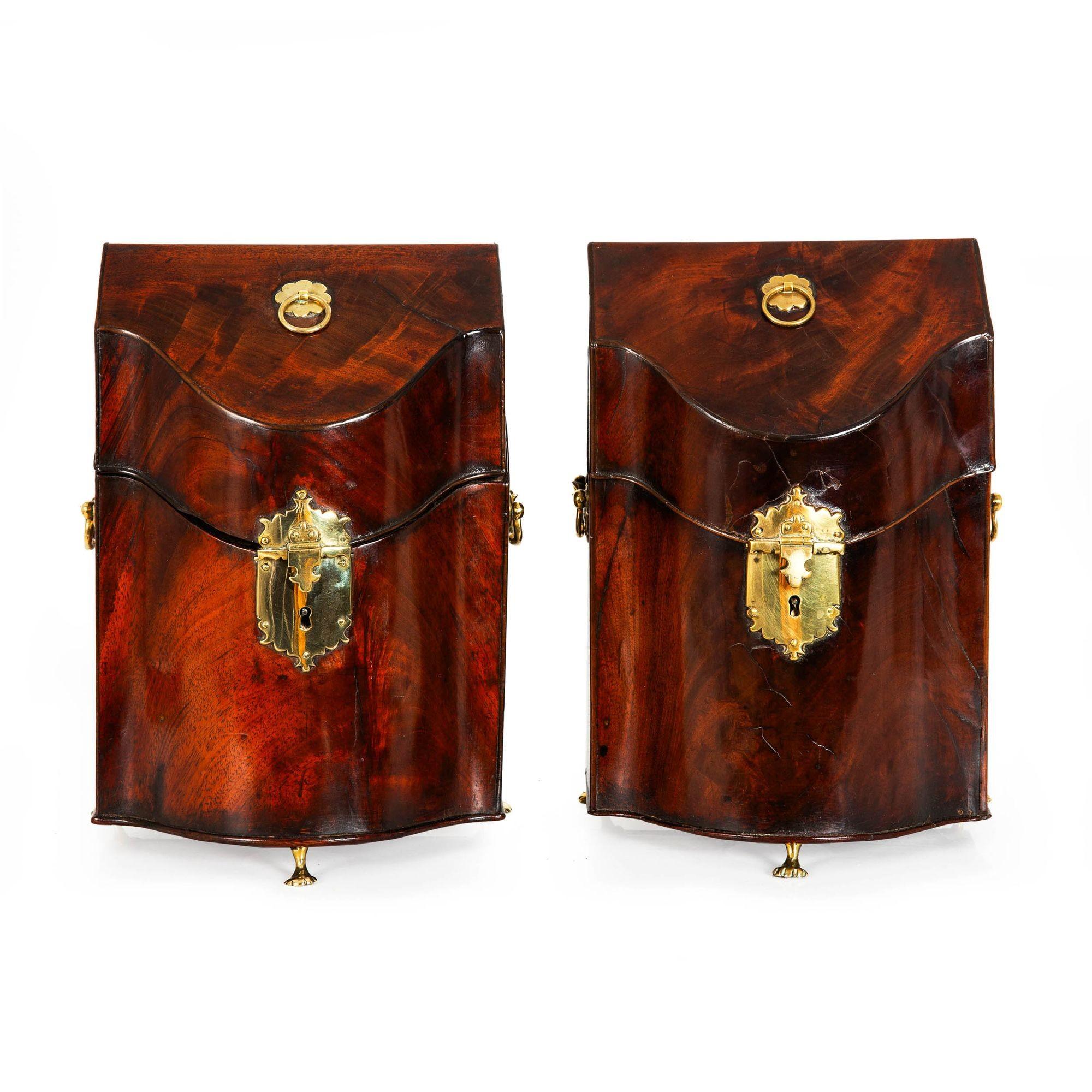GEORGE III FLAMED MAHOGANY SERPENTINE BOXES ON ANIMAL FEET
England, circa 1780  the cutlery divider removed, otherwise fine original condition
Item # 403ONQ02L

An absolutely gorgeous pair of George III peiod boxes, they present with a serpentine