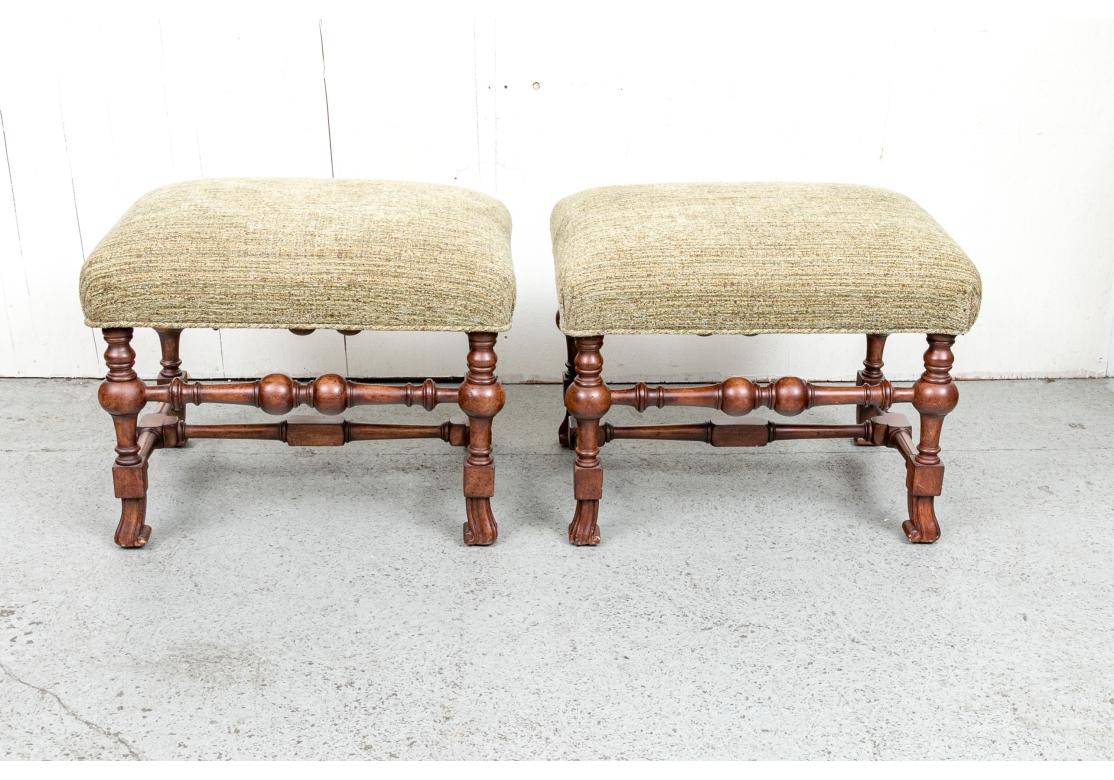 A pair of very well made, stylish and sturdy Benches in the English style. The pair feature decorative turned turned stretchers with bold and prominent bulbs echoing both Dutch and Jacobean styles along with a central stretcher. Upholstered in a
