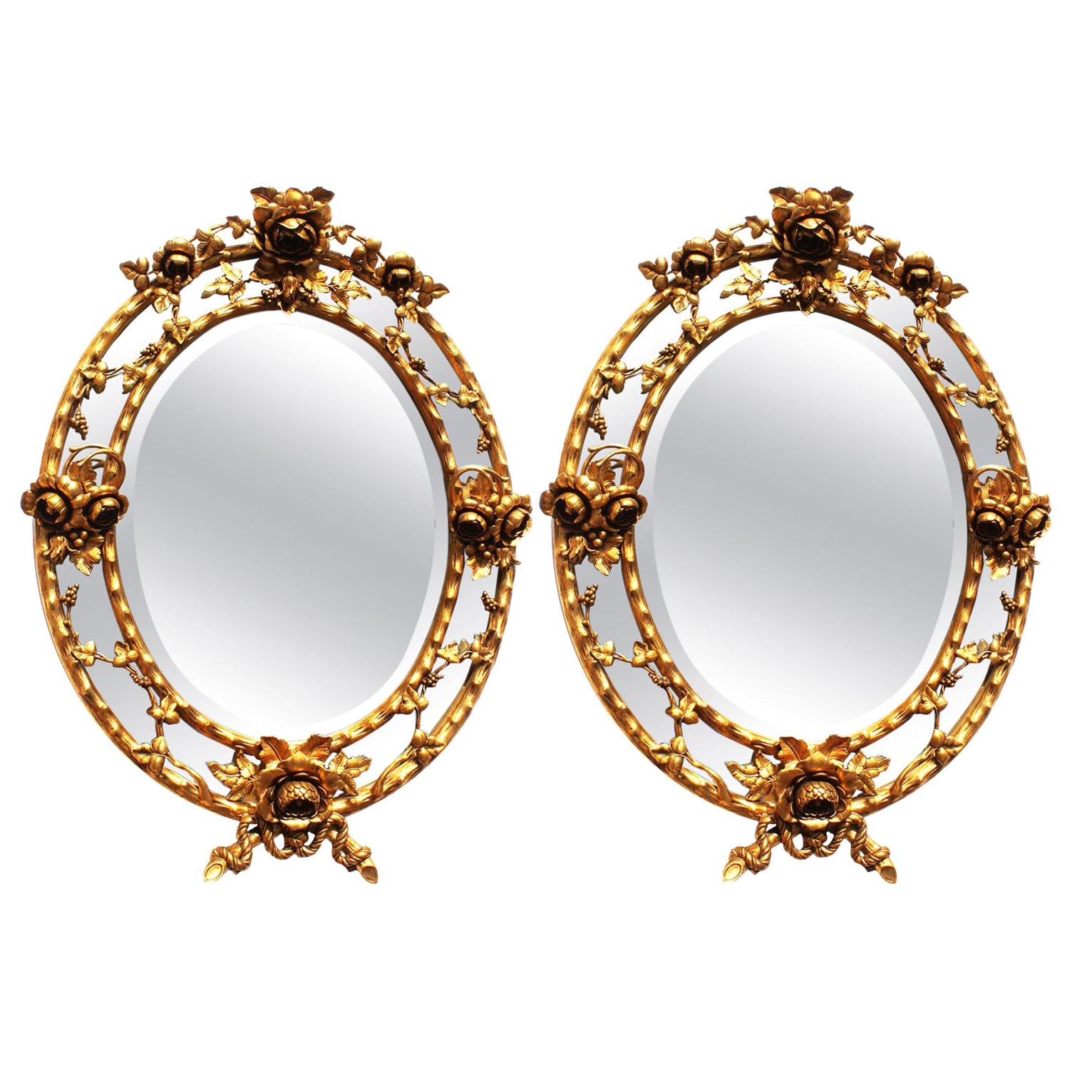 Fine Pair of French Belle Époque Giltwood and Gesso Carved Oval Mirror Frames