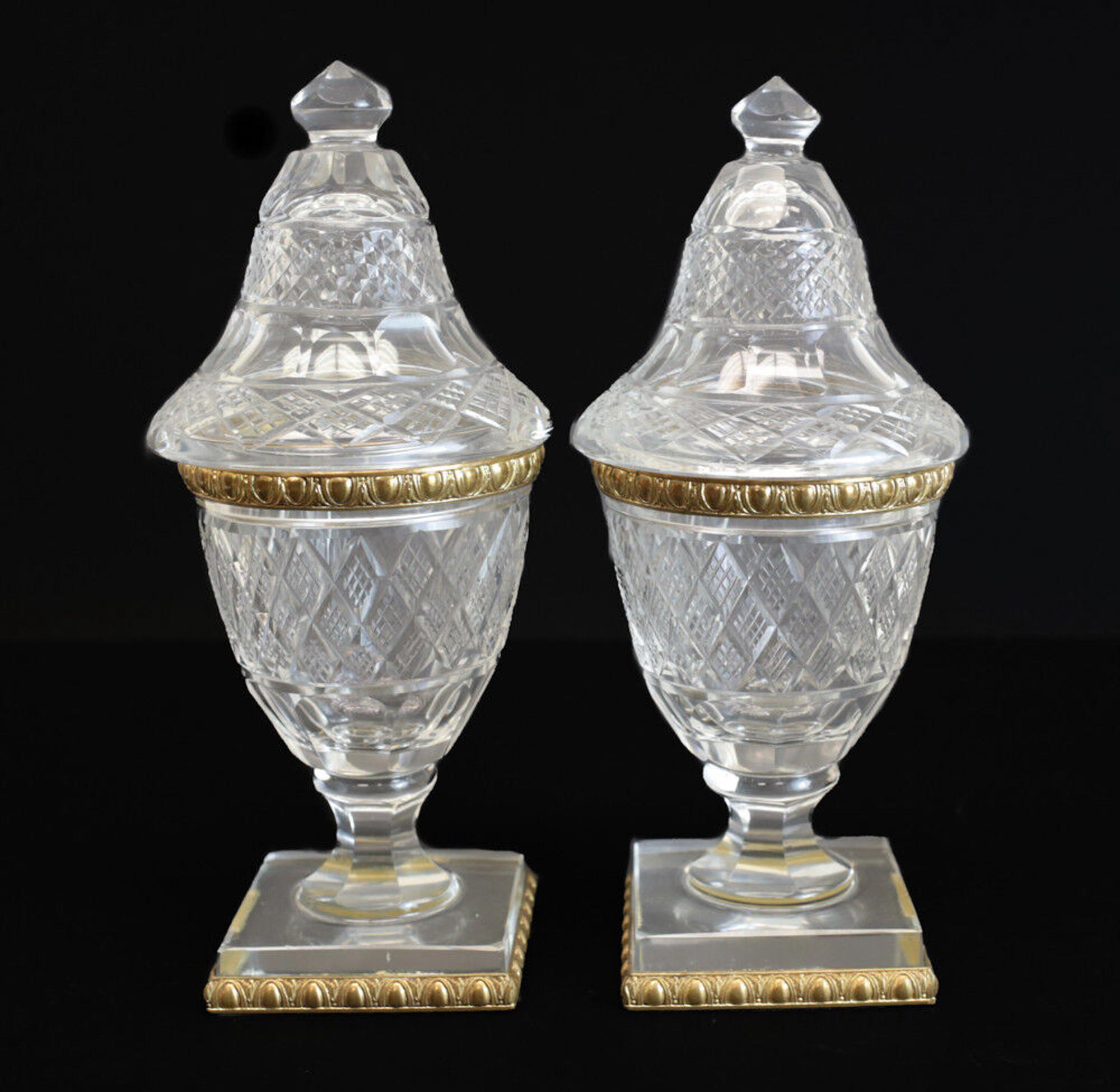 Fine Pair of French cut crystal & gilt bronze vanity jars, circa 1900

Cut crystal crosshatch diamond designs to throughout the glass. Gilt bronze to the circular bands and base.

Additional Information:
Item Width: 4 inches 
Item Length: 4