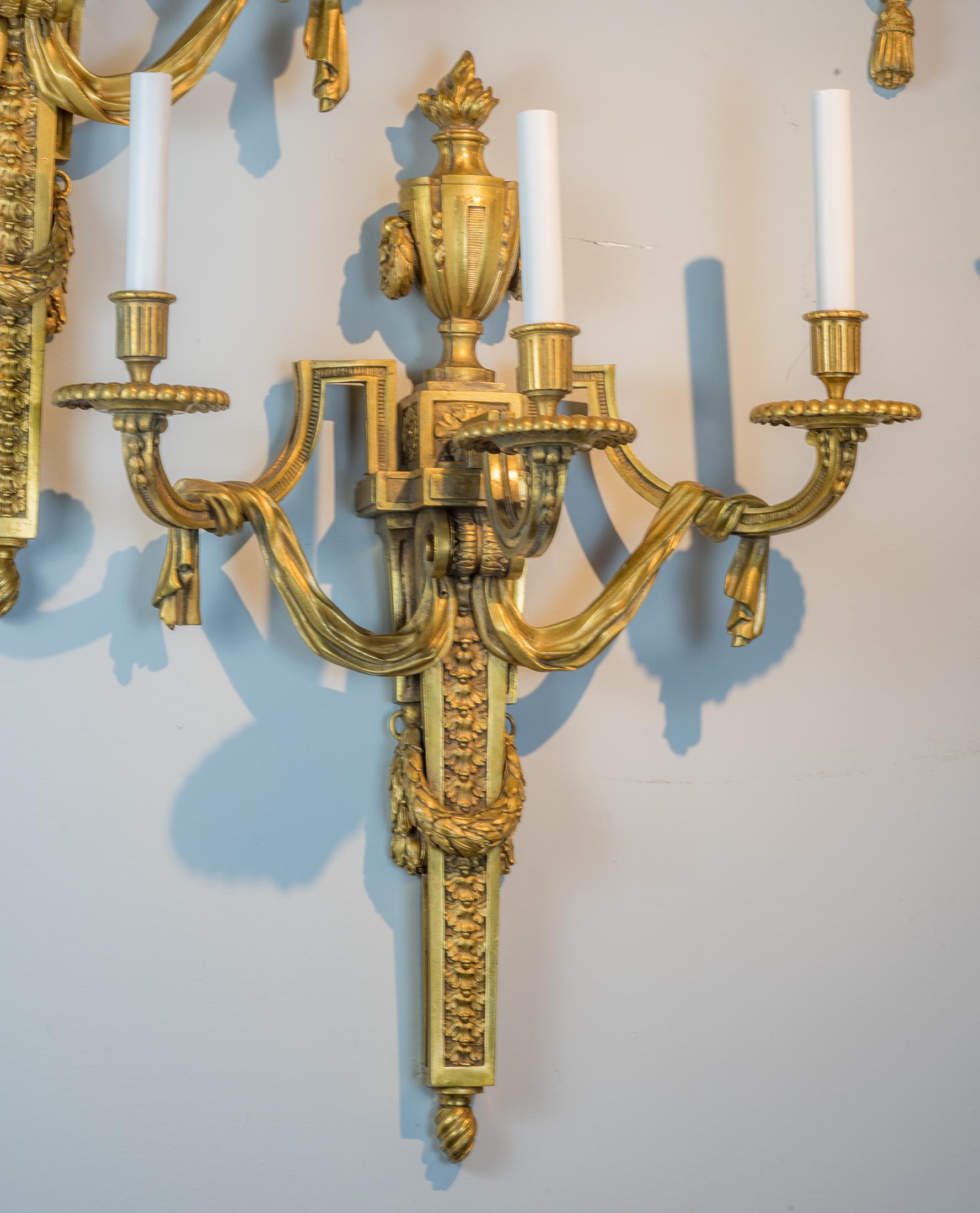 Fine quality pair of Louis XVI style gilt-bronze three-light sconces

Origin: French
Date: 19th century
Dimension: 25 1/2 in. x 20 1/2 in.