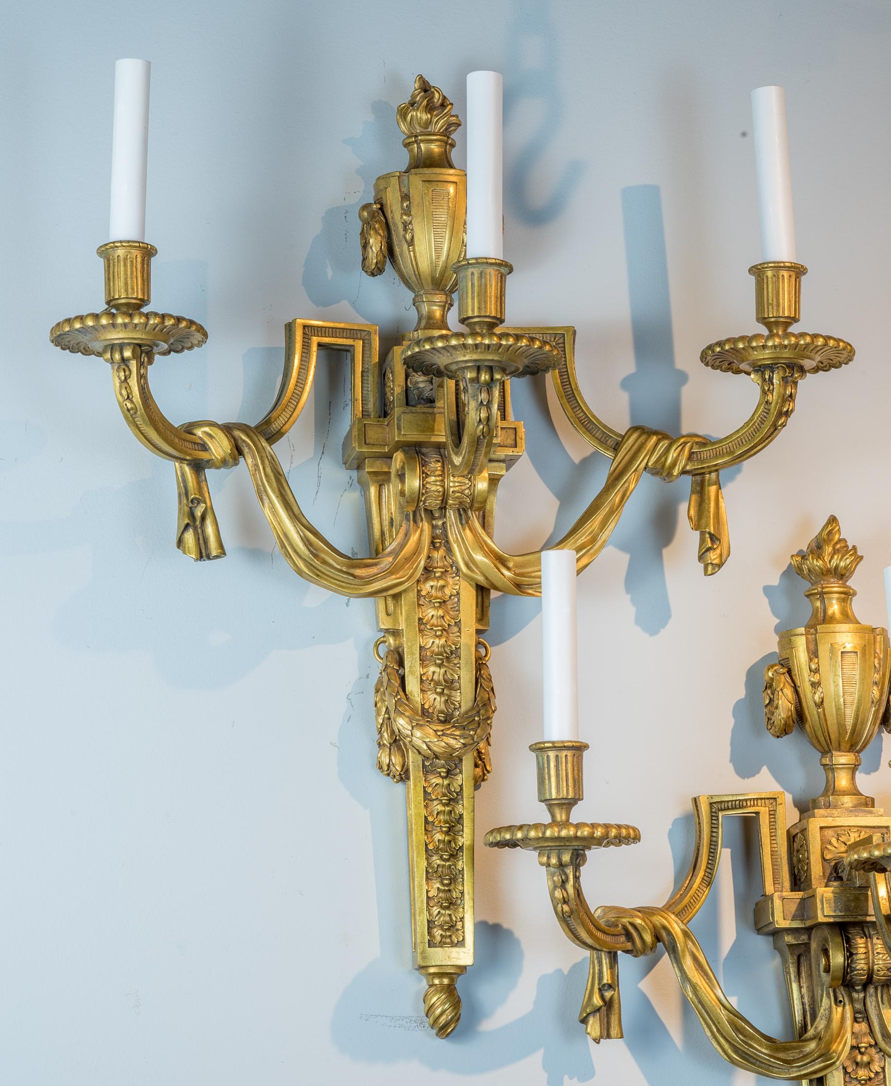 Feines Paar französischer dreiflammiger Wandleuchter aus vergoldeter Bronze (Louis XVI.) im Angebot