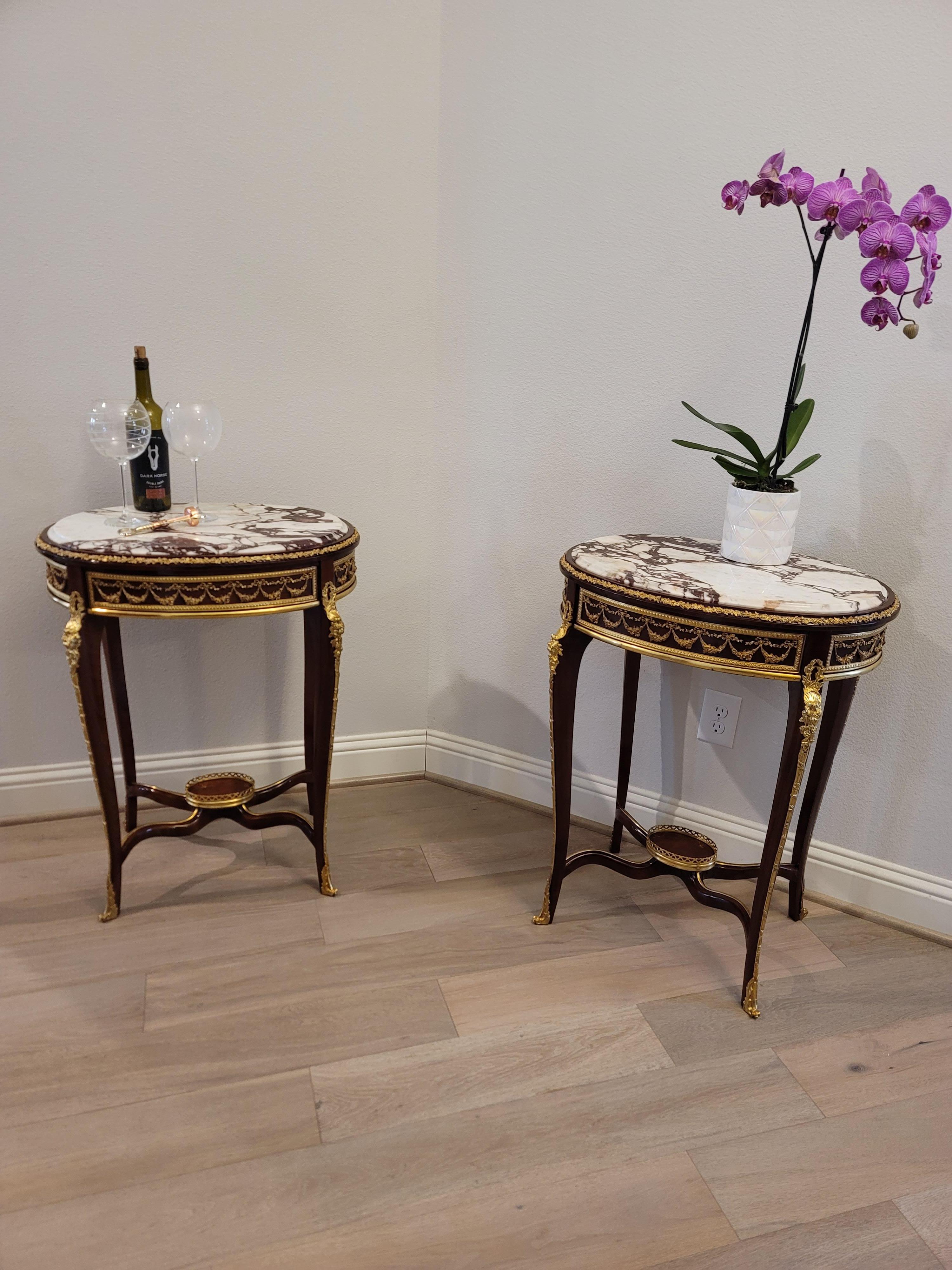A very fine pair of antique French Louis XV style gilt bronze ormolu mounted mahogany tiered side tables with breccia violetta marble tops. circa 1900

Exquisitely hand-crafted in France at the turn of the late 19th / early 20th century, most