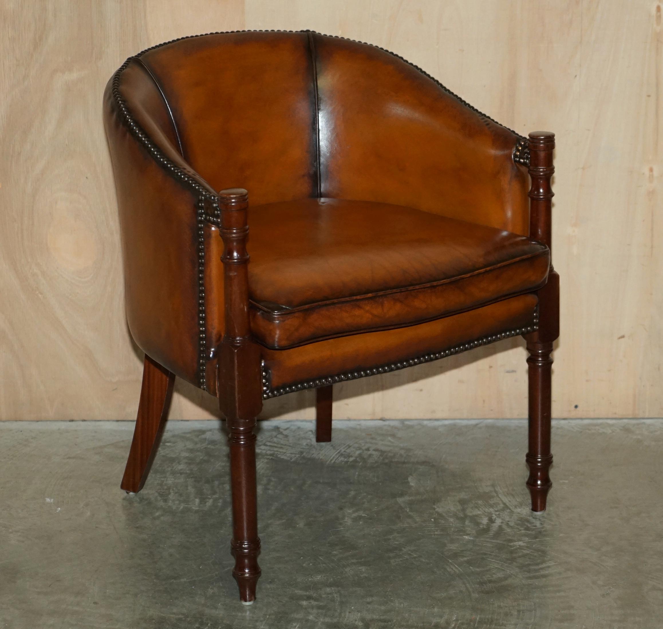 We are delighted to offer for sale this lovely pair of fully restored hand dyed cigar brown leather tub armchairs 

A very good looking and comfortable pair of armchairs, they have stunning turned beach legs which run all the way to the tops of