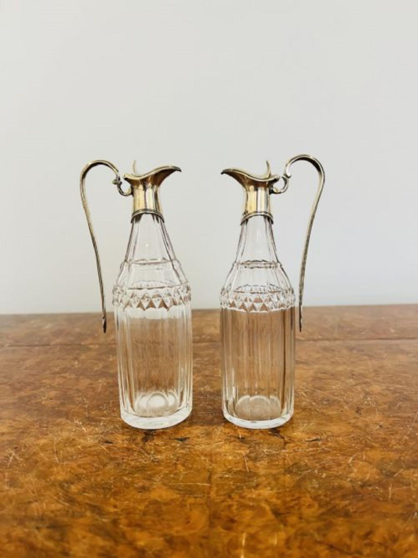 Fine pair of George III hallmarked silver and glass oil and vinegar bottles having a quality hallmarked George III silver tops with shaped handles and lids, original fine cut glass oil and vinegar bottles by Robert and David Hennell 
D. 1795