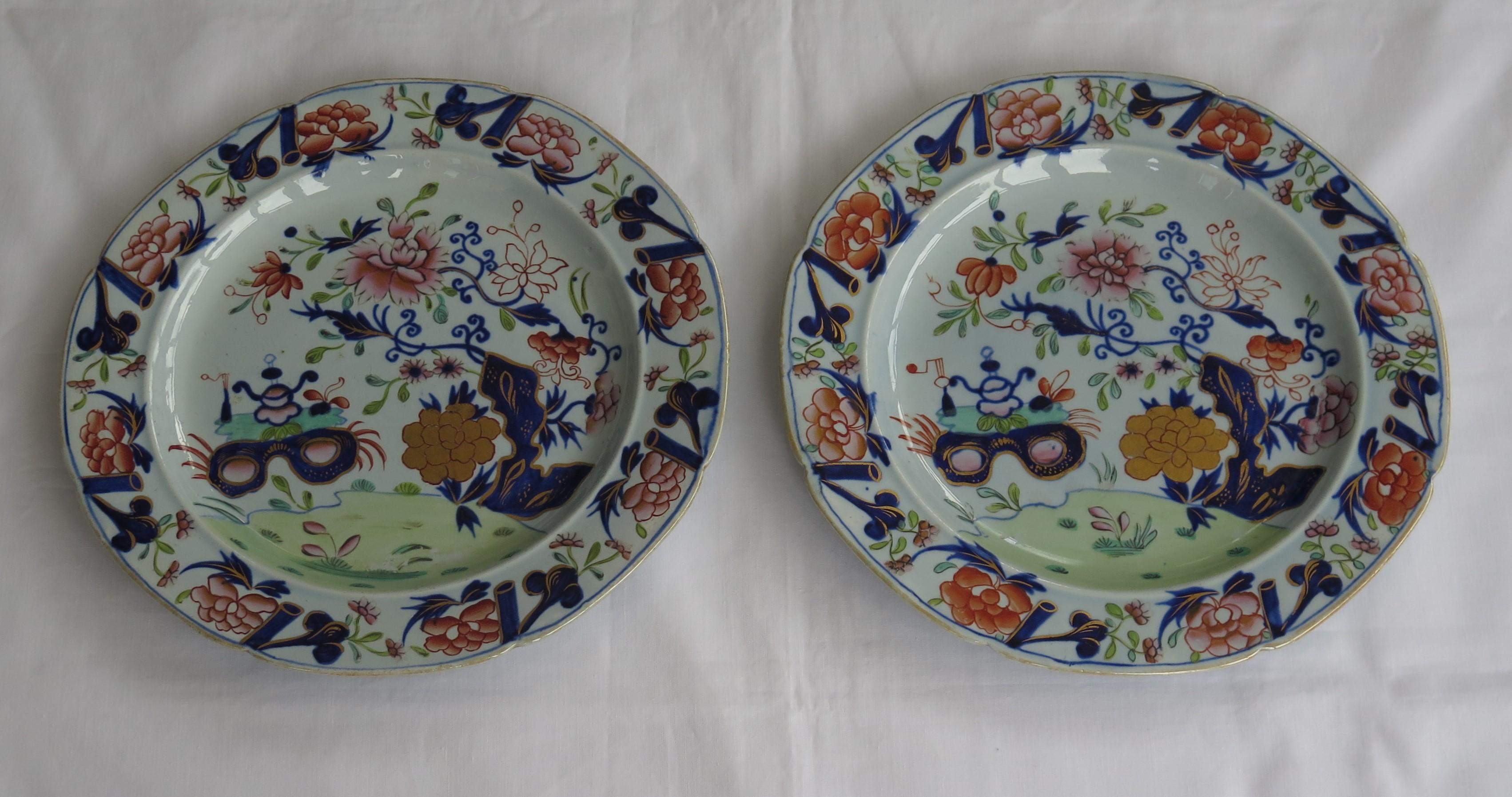 These are a fine pair of ironstone pottery dinner plates made by the Mason's factory at Lane Delph, Staffordshire, England and beautifully decorated in the small vase, flowers and rocks pattern, fully stamped and dating to the earliest period of