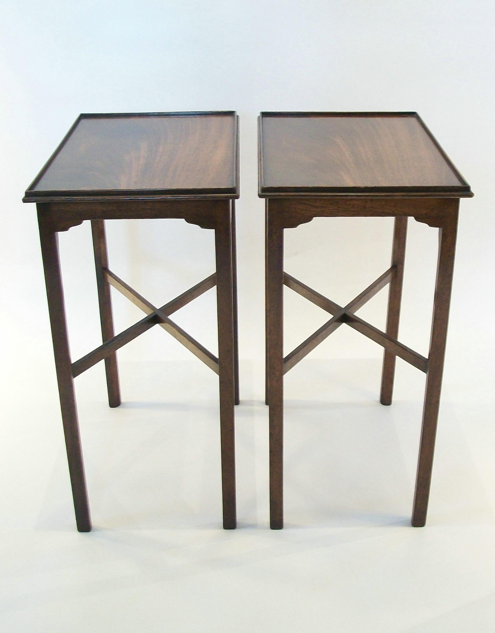 Fine pair of elegant Georgian style hardwood side tables - exceptional quality with warm patina - featuring flamed wood tops with galleried edges - finished on all four sides - interior chamfers to the straight legs with cross stretchers - plain