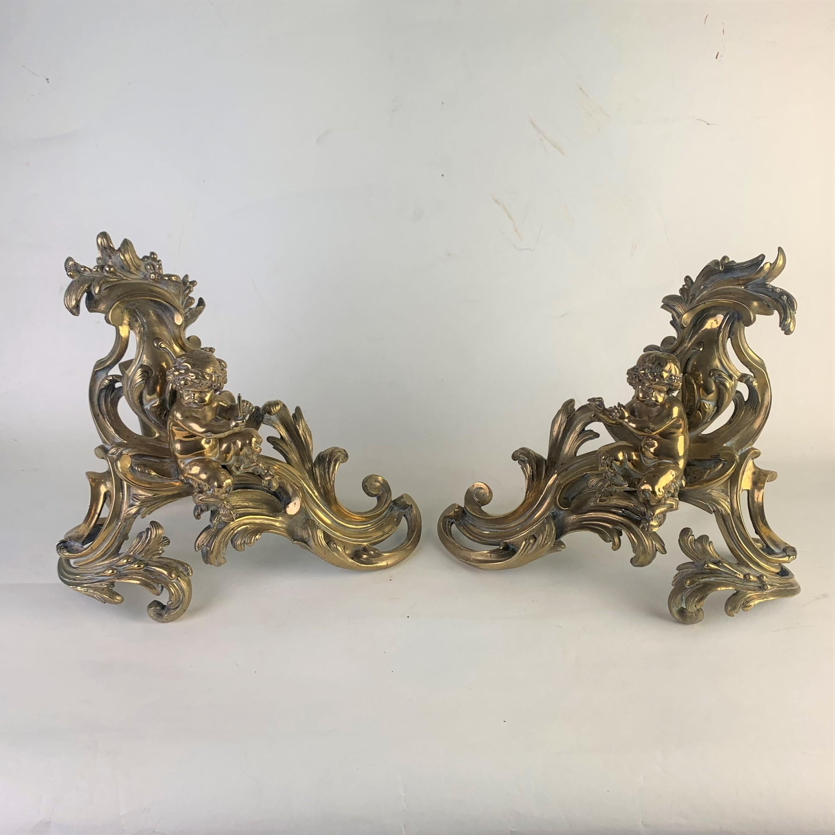 A very fine pair of late 19th century, opulent gilded brass fire chenets in the rococo taste. Depicting seated baby fawns holding candles within fancy scrolls.
Highly decorative examples original made for standing either side of a grand fireplace.