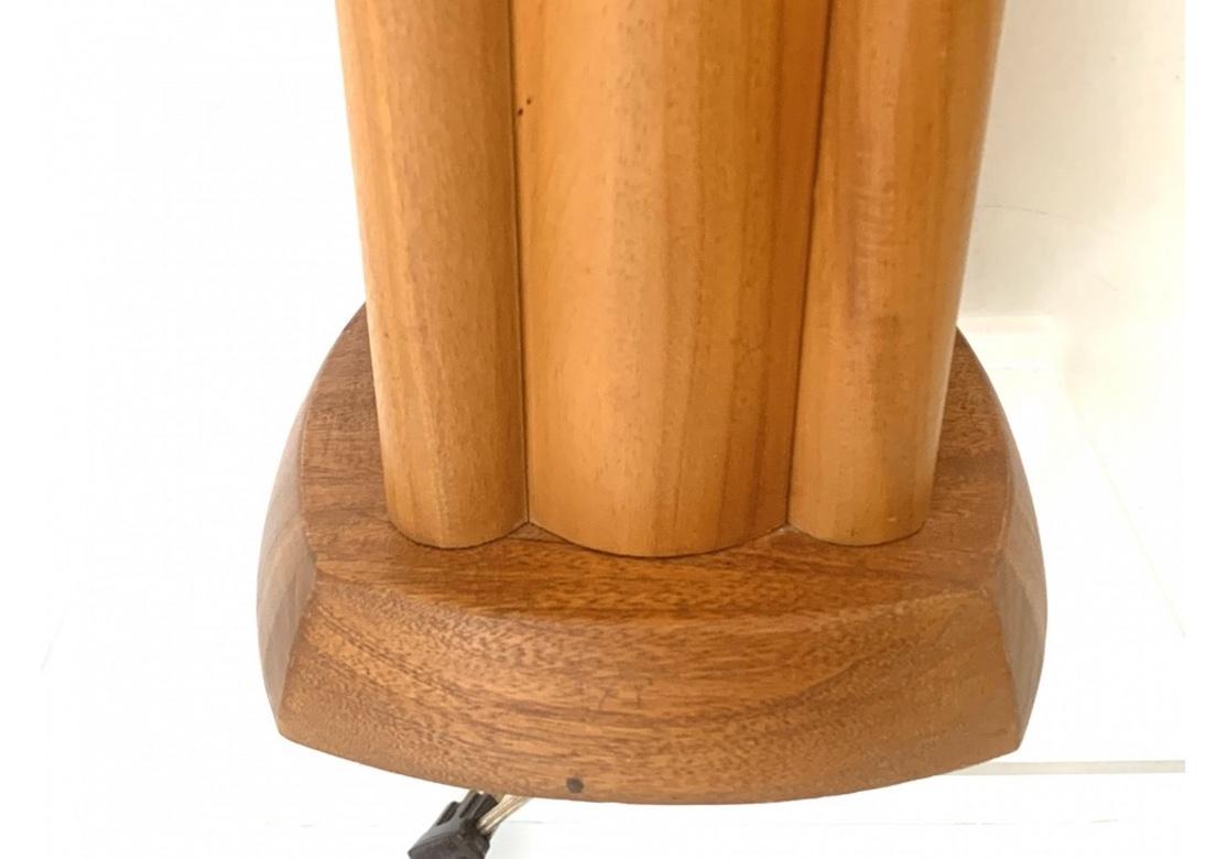 Very well made and finished Mid Century Walnut Lamps with an Architectural presentation reminiscent of the wood work seen in the designs of Frank Lloyd Wright. Pair of  Walnut Mid Century  table lamps with tall scalloped form mimicking skyscrapers