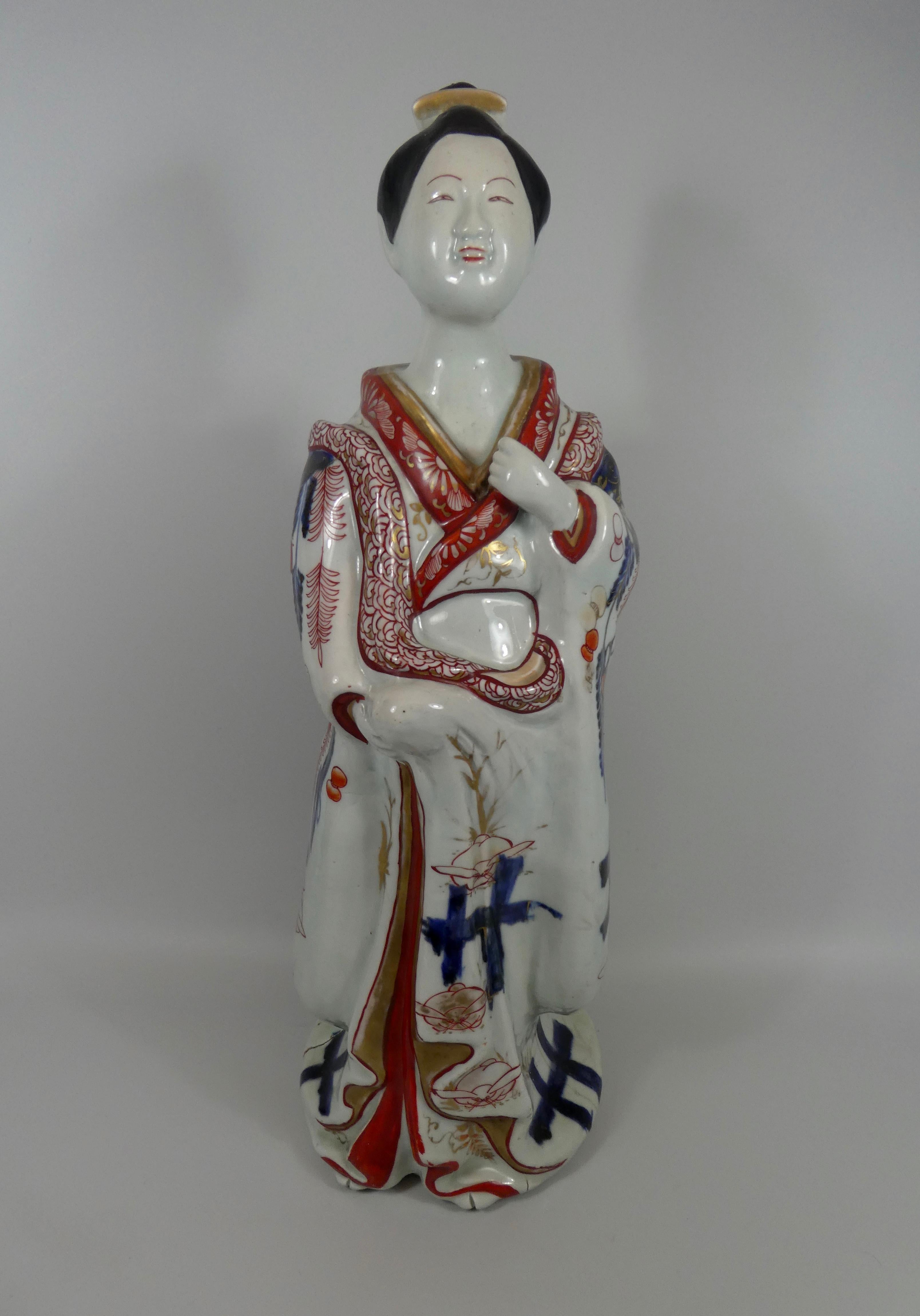 A fine pair of Japanese Imari Bijin, late 17th century, Genroku Period (1688-1704). Both figures modelled, standing with their left hands raised to their chests, whilst their right hands clutch their robes. Their kimonos, elaborately painted with