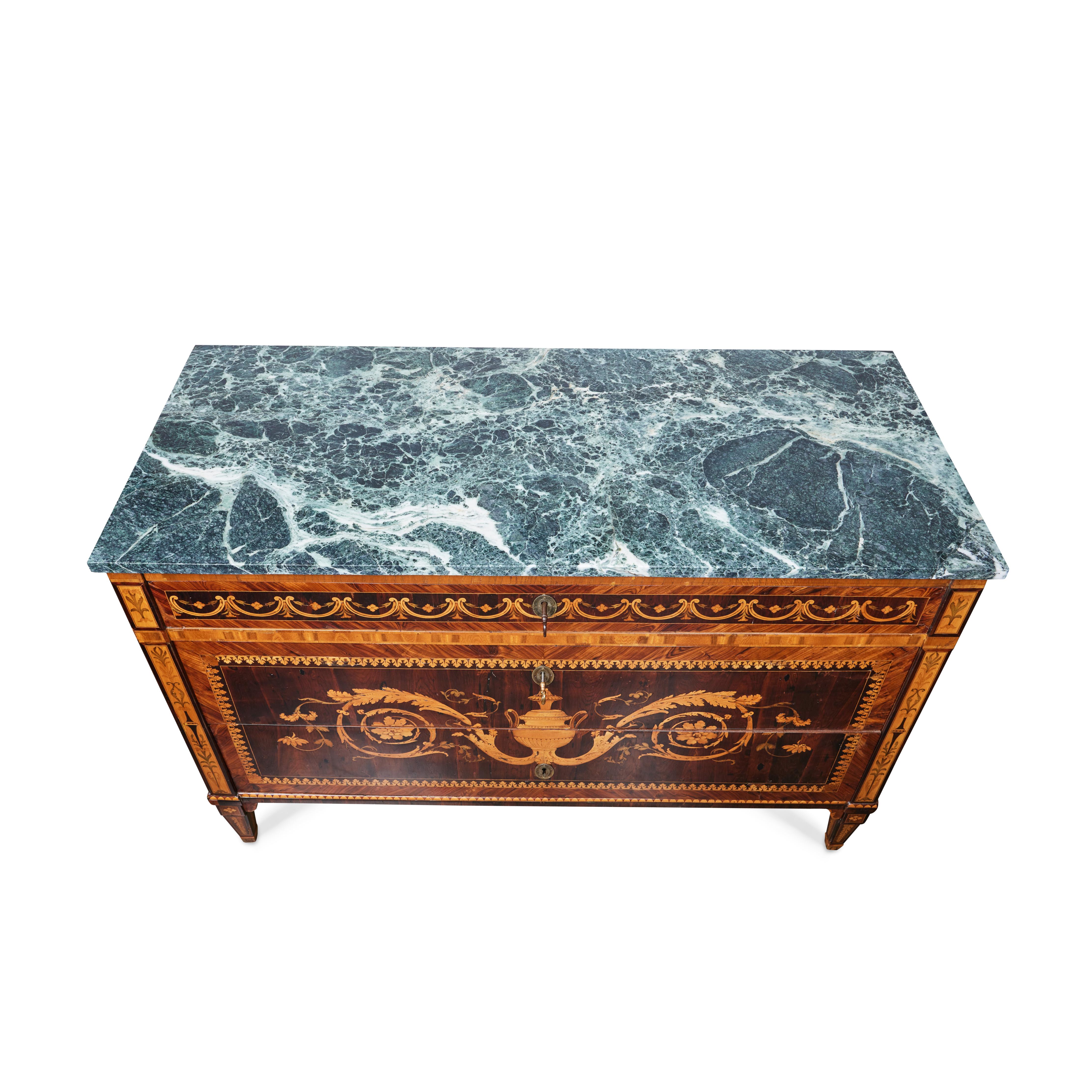 Fine pair of veneered and inlaid commodes in various woods with original marble tops. The fronts are centered by a neoclassical vase with floral bouquets, bordered with leaves. 

Attributed to furniture designer Giuseppe Maggiolini (Parabiago,