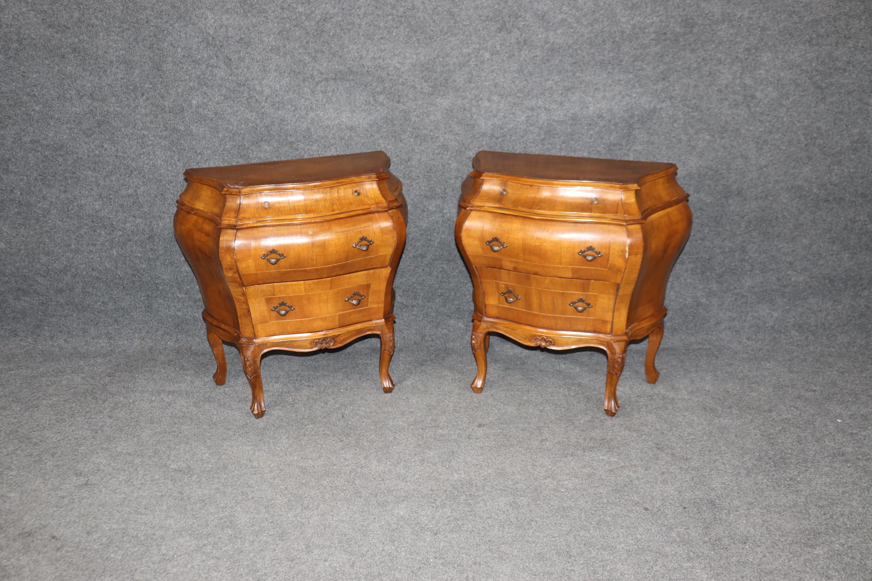 This is a superb pair of bombe form Louis XV style Venetian commodes or nightstands. They are made of Olivewood and in good condition with minor signs of age and wear such as minor scratches or scuffs and age cracks in surface areas but nothing