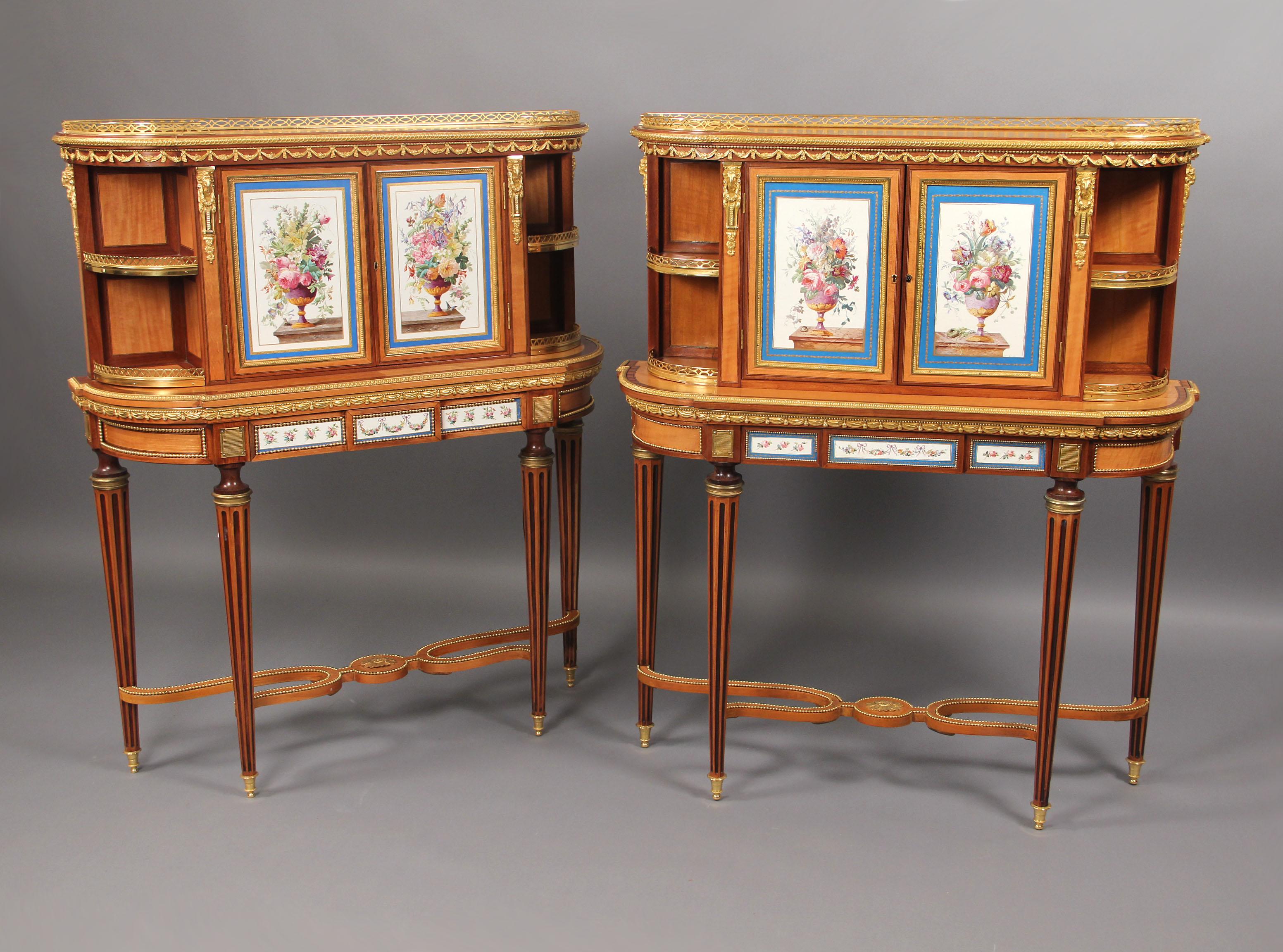 A very fine pair of late 19th century gilt bronze and Se`vres Style porcelain mounted kingwood cabinets. 

The upper section with a pair of doors with Sevres style porcelain plaques painted with a flower filled urn, the lower section with a frieze