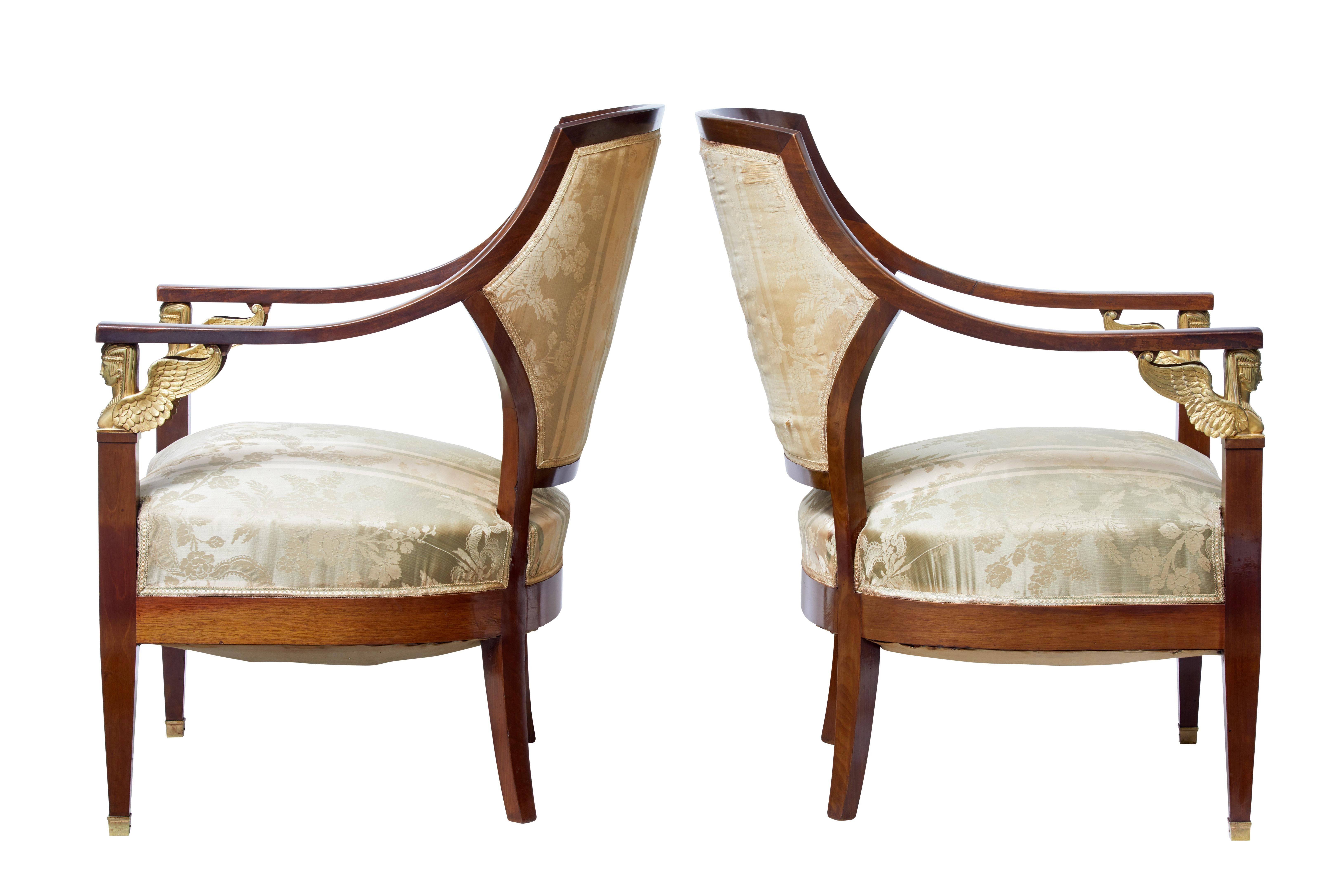 Fine quality pair of French mahogany armchairs in the Empire taste, circa 1890.

Shaped back and arms to this elegant pair of chairs with Egyptian ormolu mounts below the arm.

Standing on tapered legs with brass caps to the front legs.

In