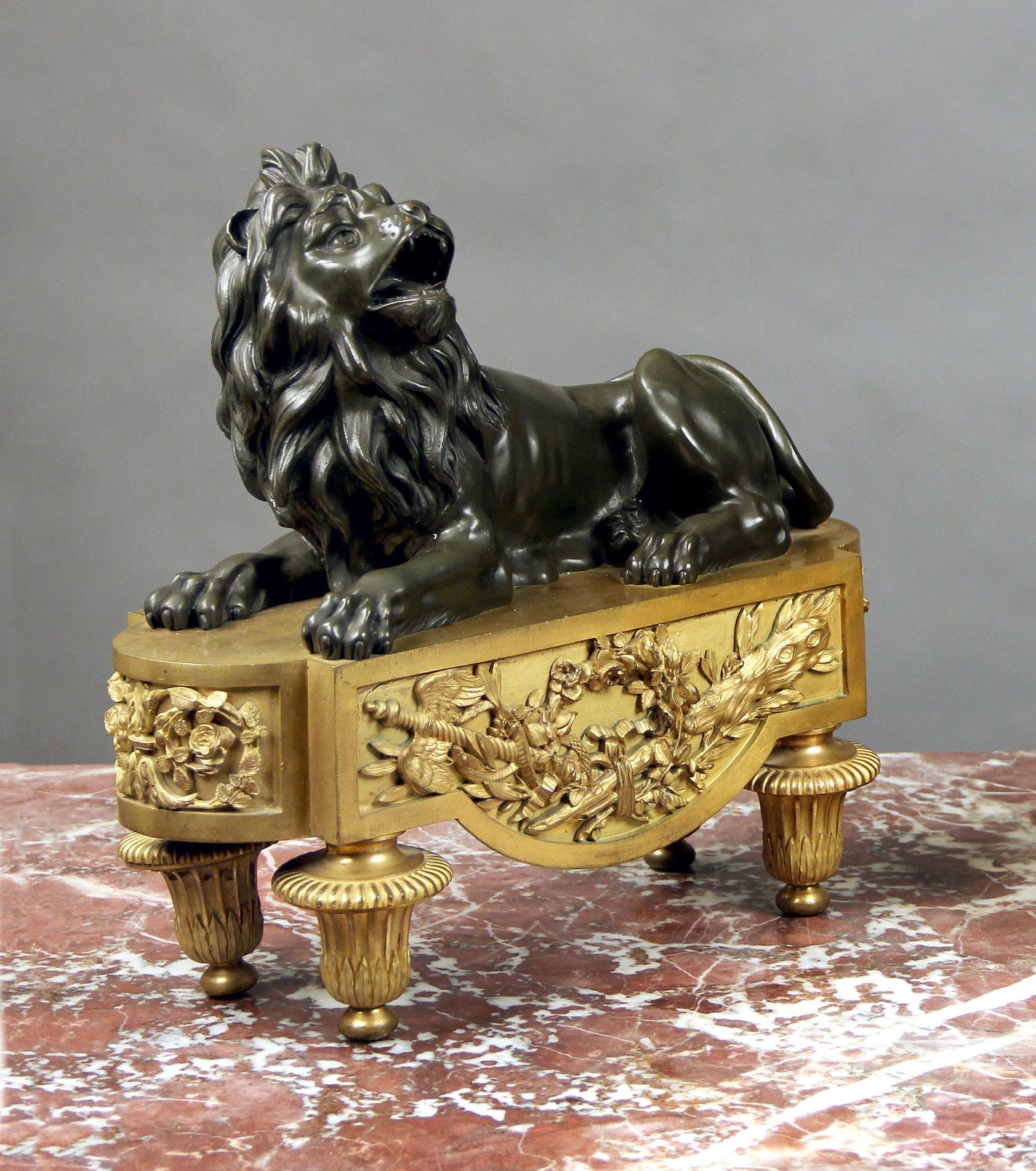 A Fine Pair of Late 19th Century Gilt and Patina Bronze Chenets

Each of a lion seated and roaring on a gilt base with a flower reef design.