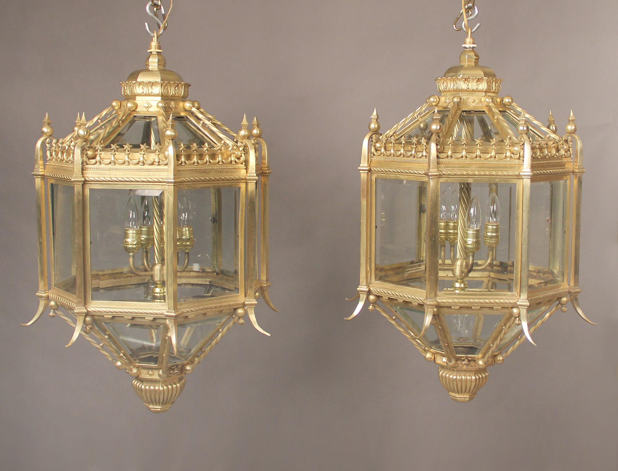 A fine pair of late 19th century gilt bronze five-light lanterns.

The lanterns of octagonal form with a pieced gallery with stars circling the top. Five interior lights.

