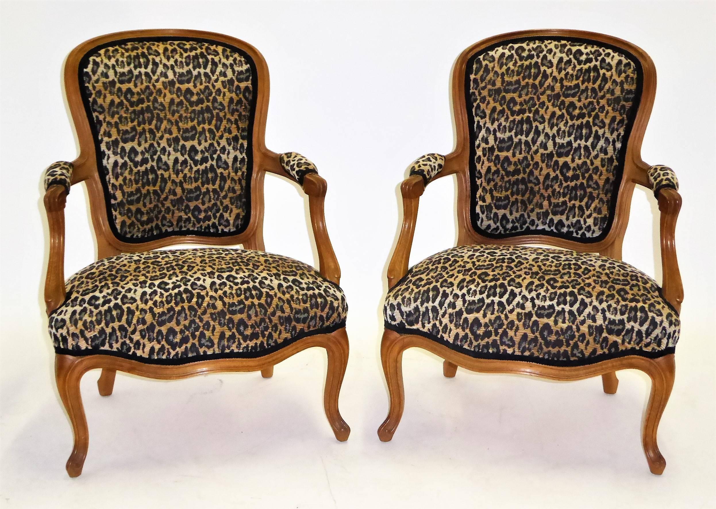 REDUCED FROM $3.850....Lovely pair of Louis XV style fauteuils beautifully carved and newly upholstered in a chenille woven leopard motif in a chauffeuse height. Made in Athens by Saridis, the famed furniture makers for which TH Robsjohn-Gibbings