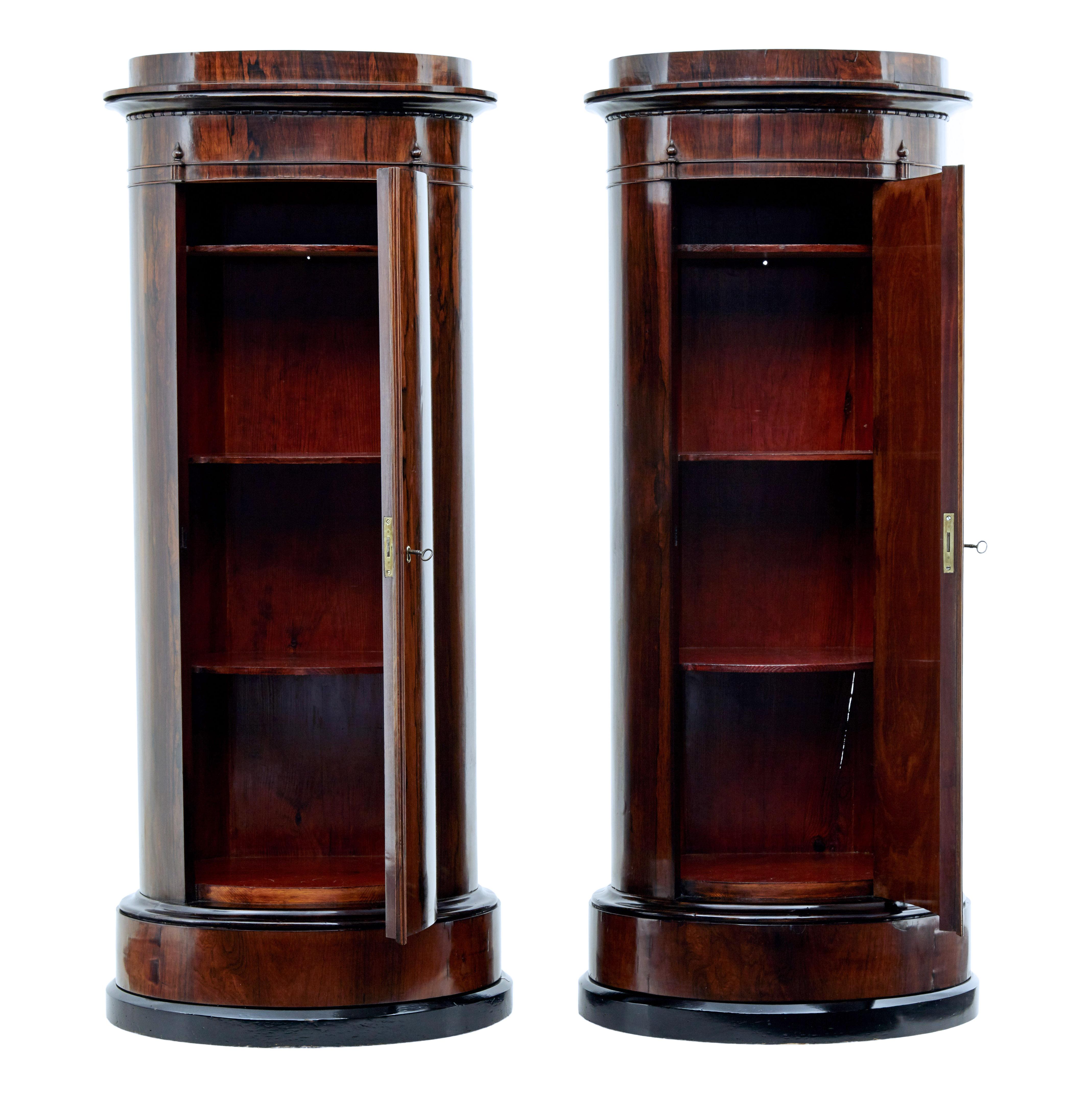 Stunning pair of palisander cabinets, circa 1860.

Rare to be still found in a pair. These pieces act as a cabinet and a pedestal for displaying busts or floral arrangements.

Single door opens to 3 fixed shelves in a polished interior.