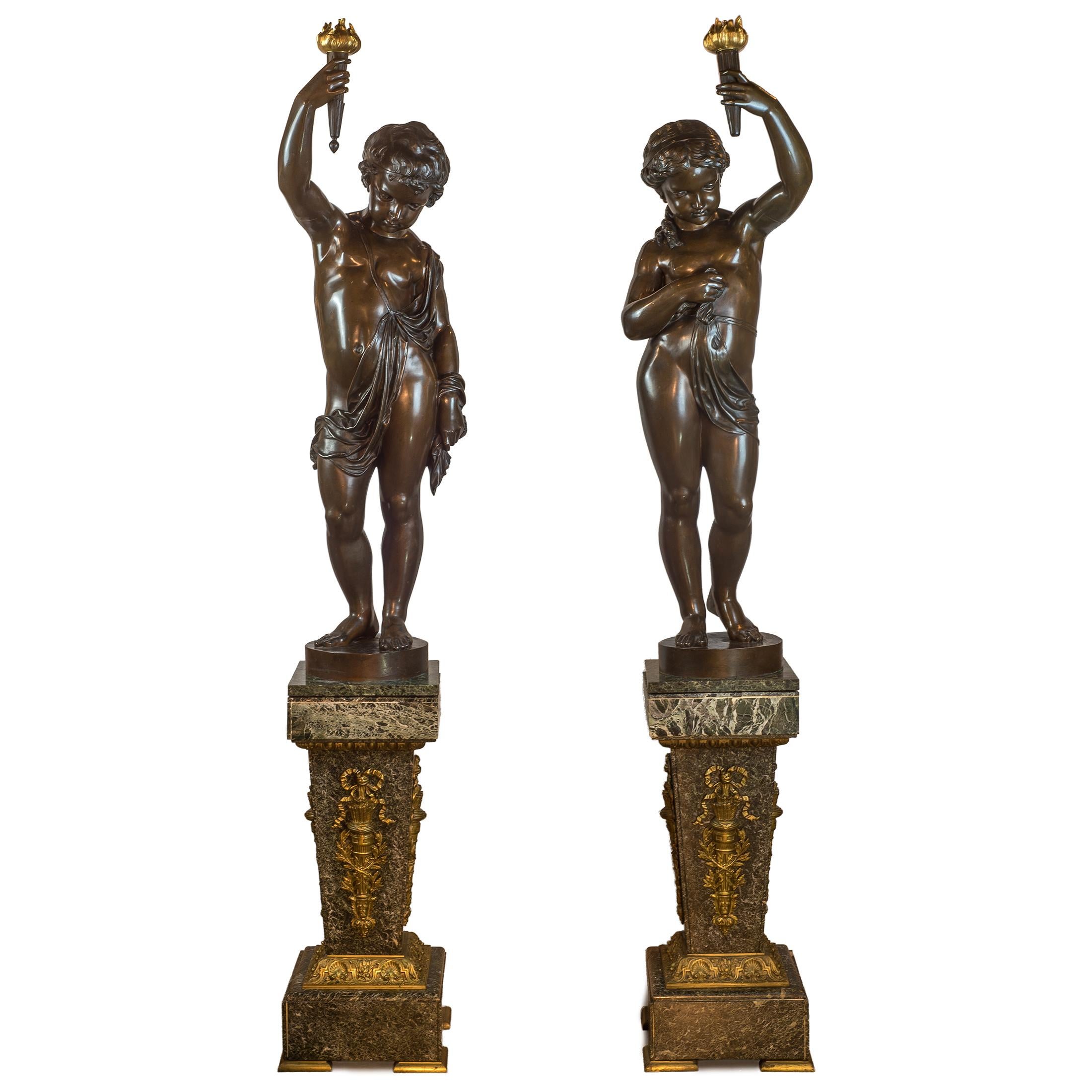 A fine 1867 exposition pair of patinated bronze figural torchères on pedestal
Maker: A. Lacarrière Père, Fils et Cie. (Mid 19th century)
Origin: French
Date: Circa 1867
Dimension: 51 1/4 in. x 15 in.(sculptures); 31 3/4 in. x 12 in.