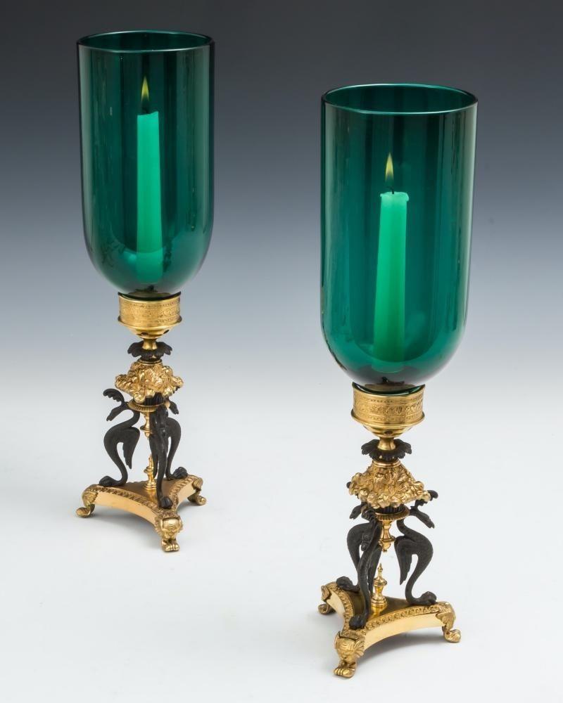 A fine pair of regency storm lights on gilt lacquer and bronze tripod bases patented by Cheney london issuing most unusual emerald green shades.

The line drawing showing different options and colouring of the bases.
