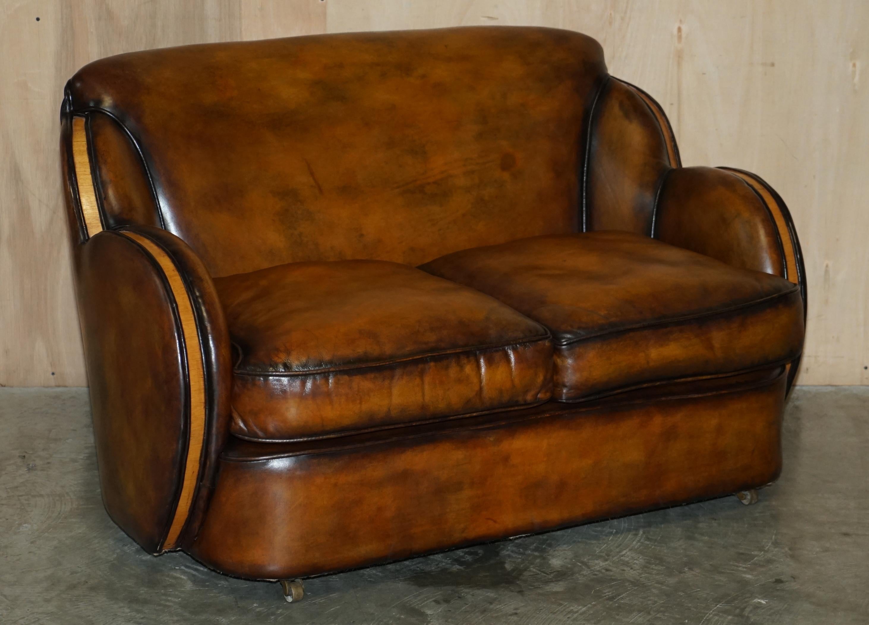 We are delighted to offer for sale this stunning pair of very rare Harry & Lou Epstein Art Deco two seat Cloud sofas with Birch frames and one of a kind, hand dyed brown leather upholstery.

A very stylish and decorative pairing. The birch panels