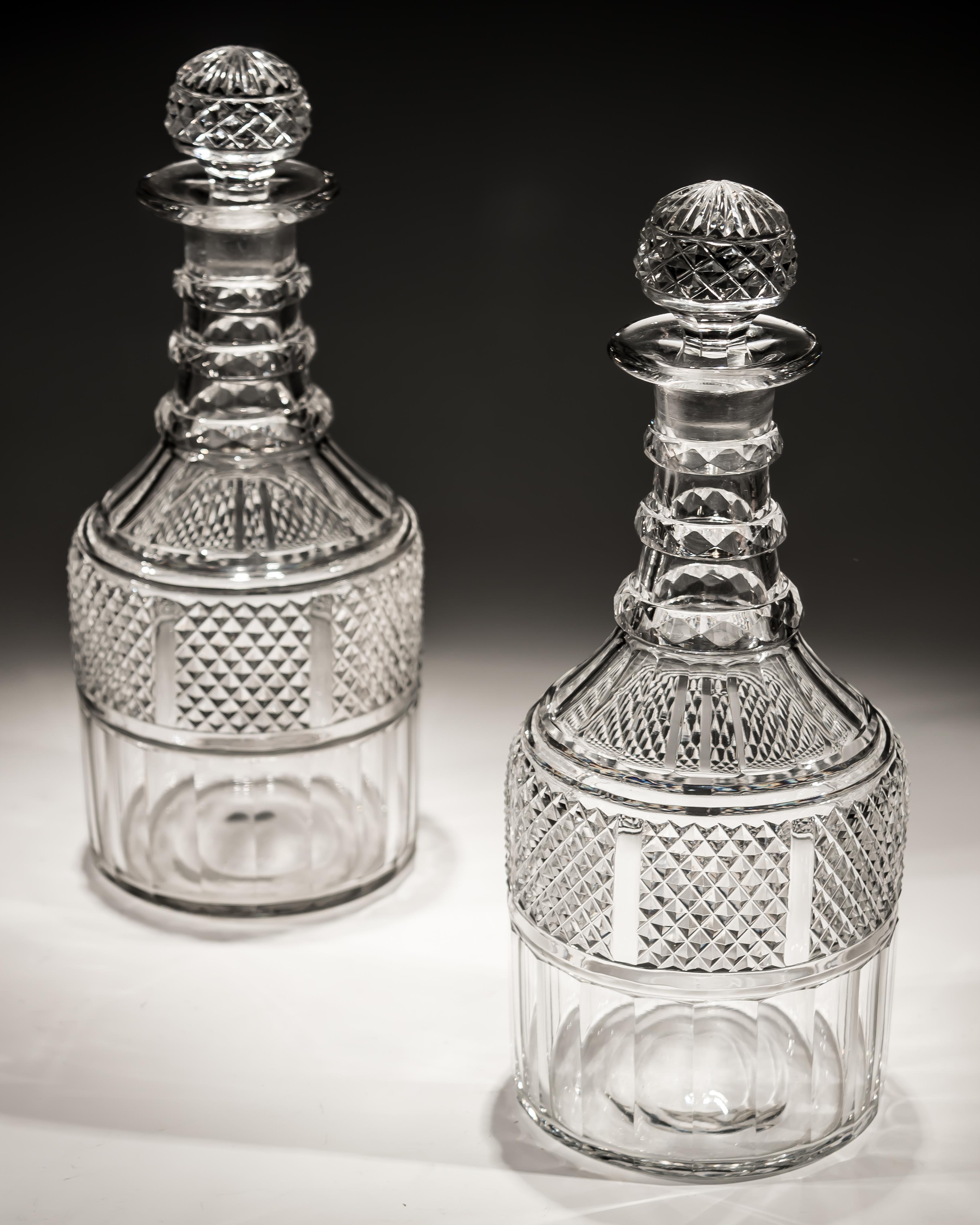 A fine pair of slice and diamond cut Regency decanters.